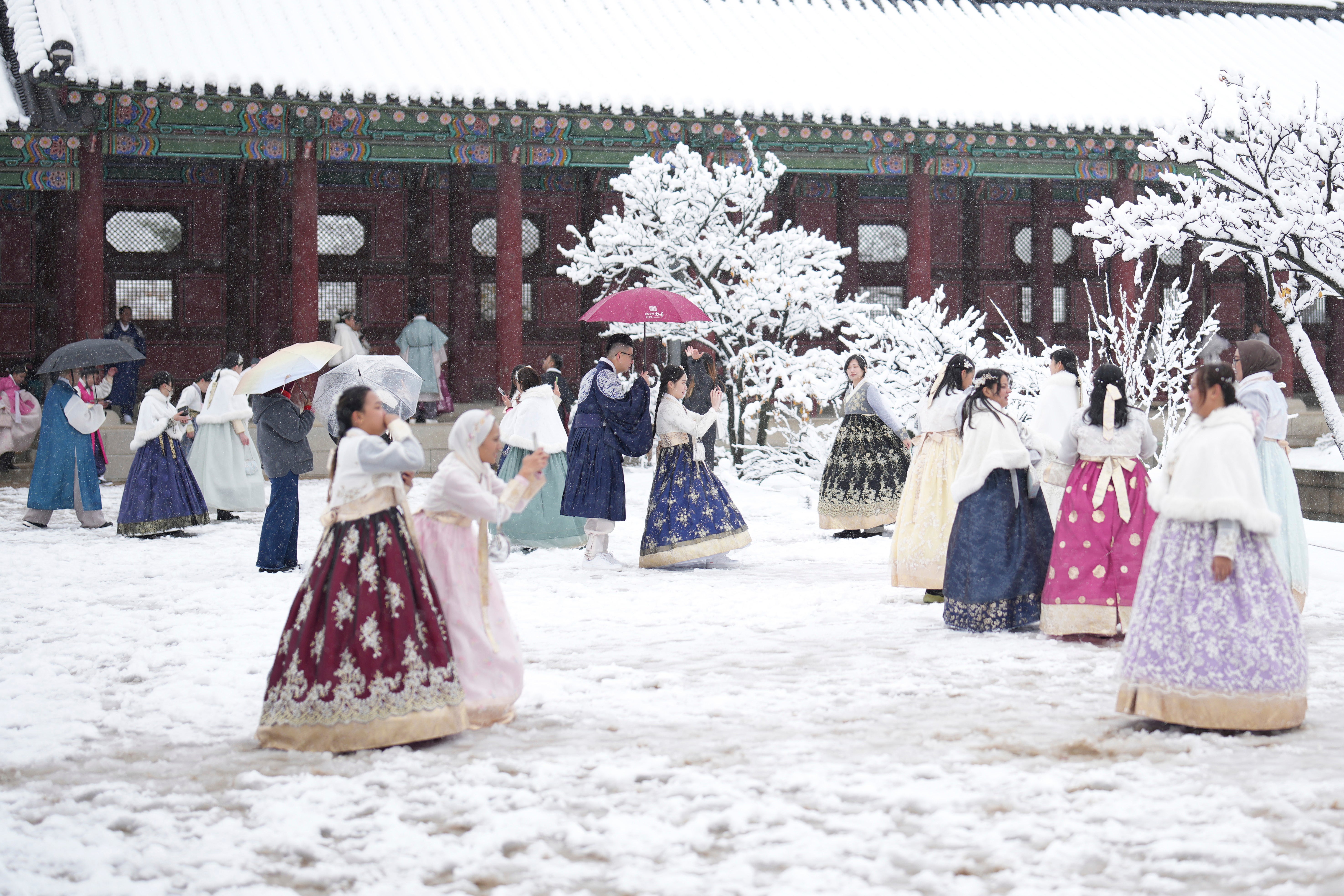 Visitors enjoy in snow at the Gyeongbok Palace, one of South Korea's well-known landmarks