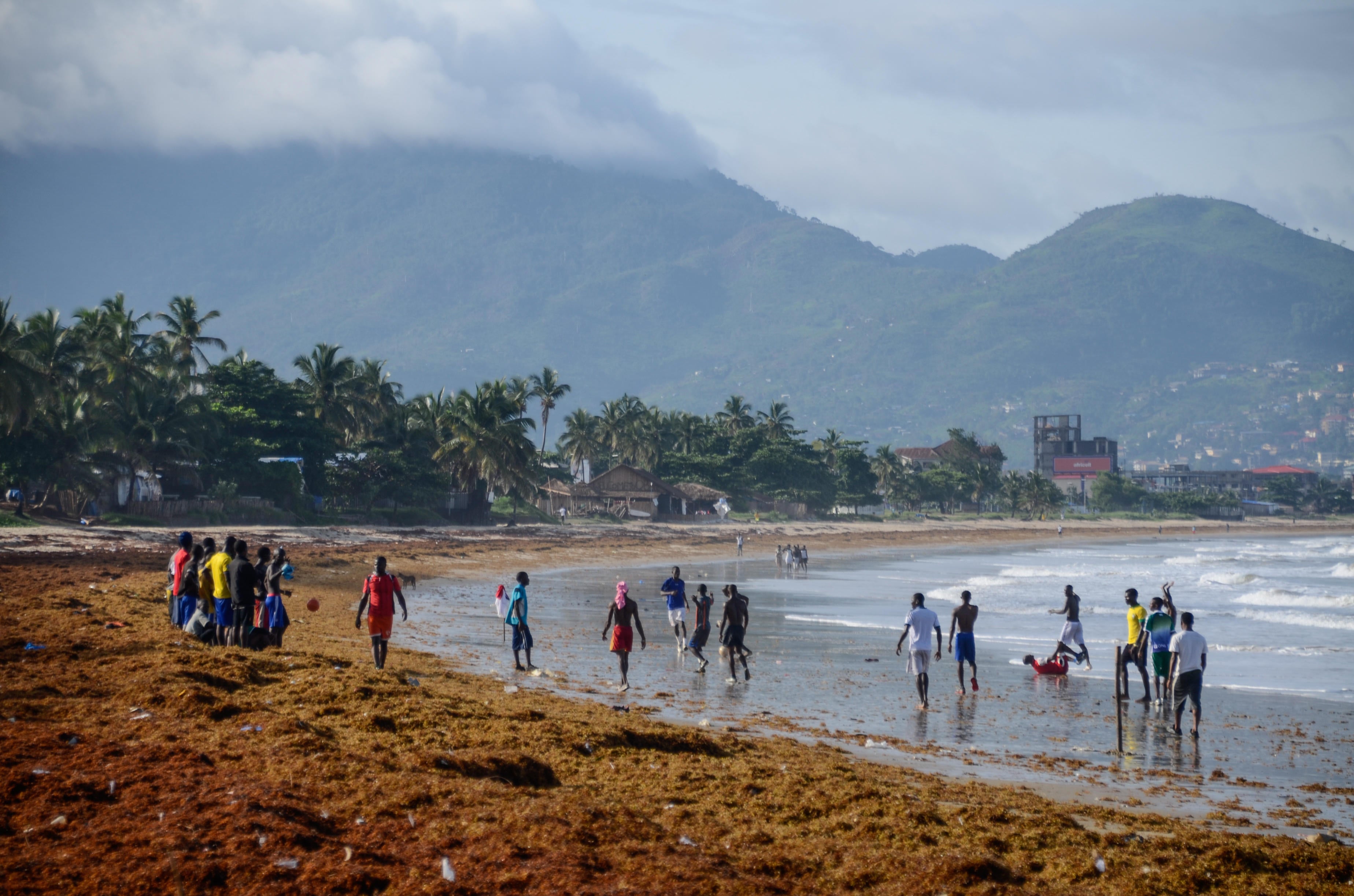 Footballers on Lumley Beach during the rainy season