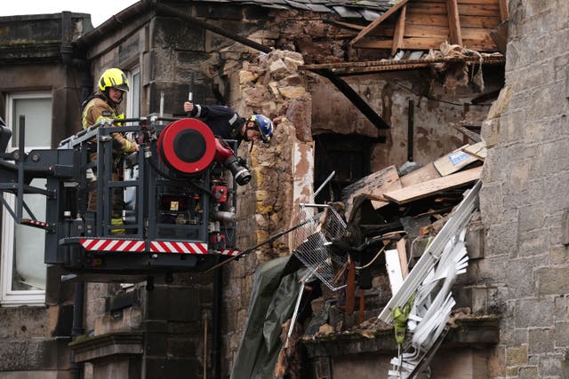 Fire investigators at the scene at Kellie Place in Alloa, Clackmannanshire (Andrew Milligan/PA)