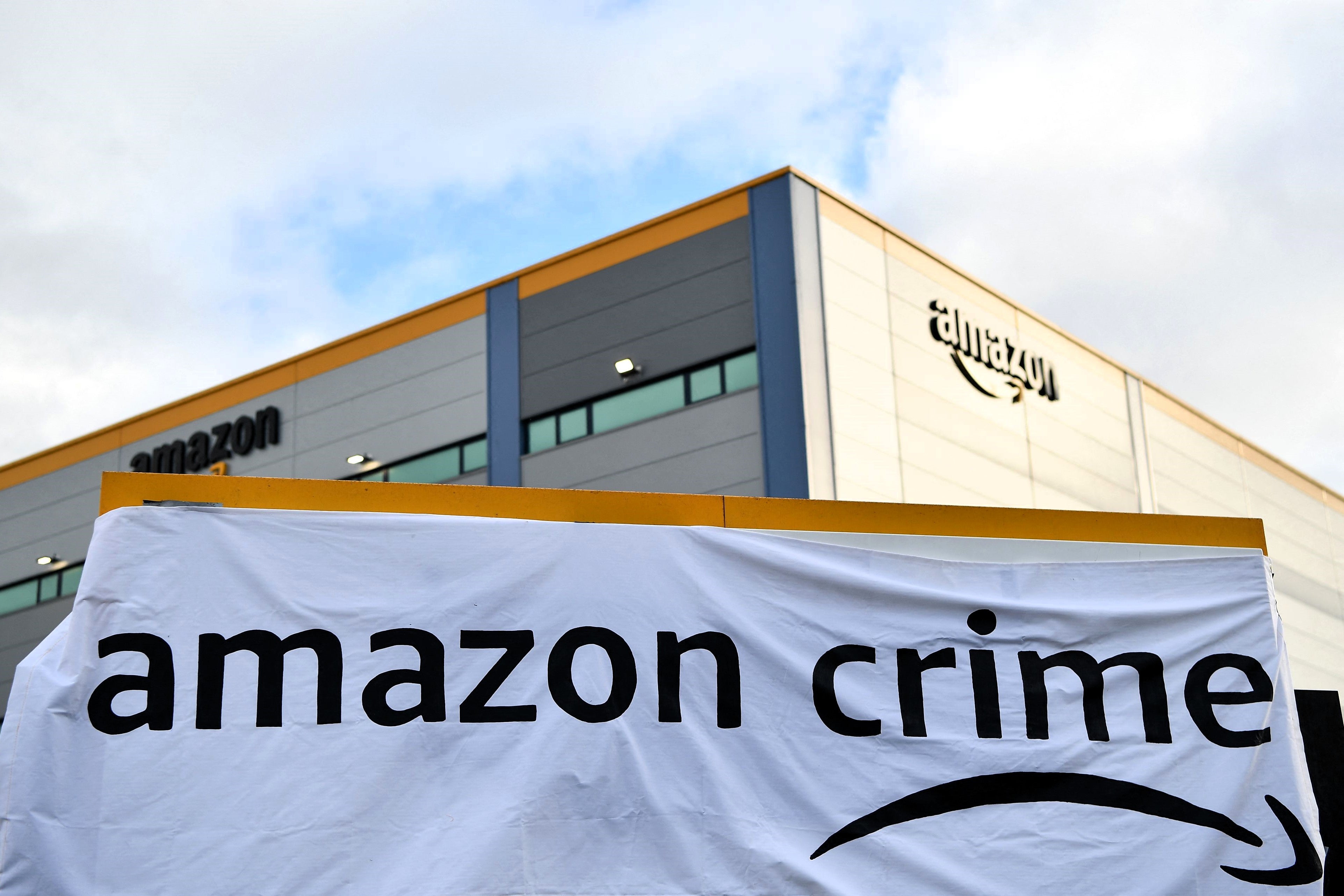 A banner is pictured outside an Amazon distribution centre in Tilbury, east of London, on 26 November, 2021