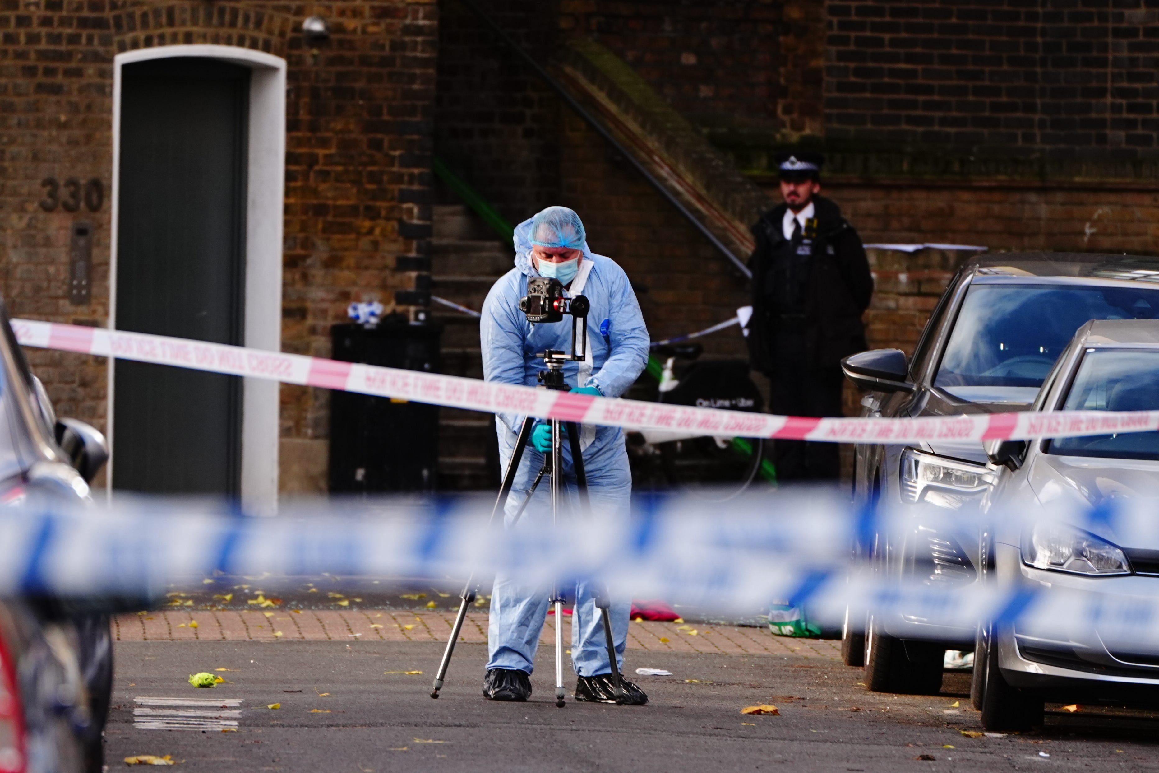 A police forensic officer at the scene in Ladbroke Grove, west London, after an eight-year-old girl was seriously injured when she was shot (Aaron Chown/PA)