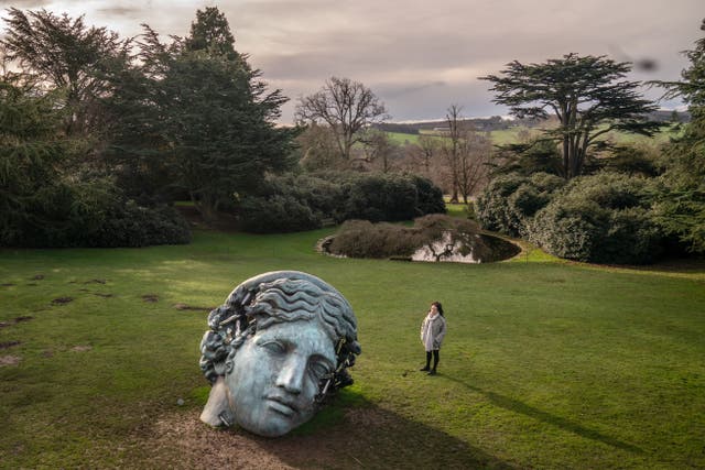 Dominique Lynch views Daniel Arsham’s Unearthed, Bronze Eroded Melpomene, at the Yorkshire Sculpture Park in Wakefield, West Yorkshire. (Danny Lawson/PA)