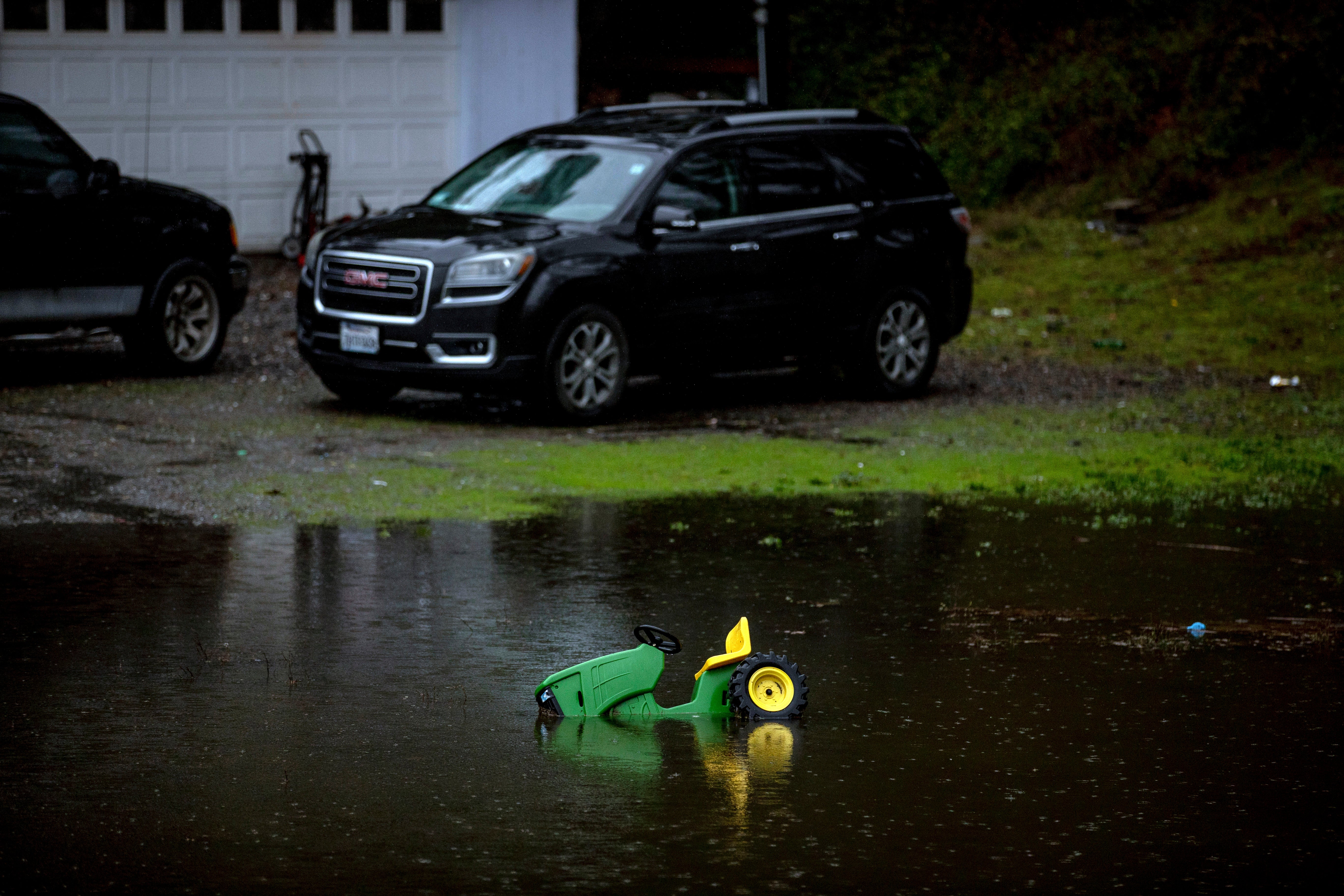 A toy car is seen partially submerged in flood water near a home in coastal Fortuna, California, last week. Much of California was inundated with rain and snow in the historic atmospheric river event. Across the US, a new report from Climate Central has found that some 400,000 US children live in areas that will be vulnerable to major coastal flooding events by 2030