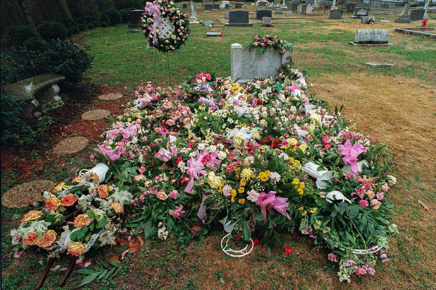 The gravesite of JonBenet Ramsey covered with flowers, January 8, 1997, at St. James Episcopal Cemetery in Marietta, Georgia