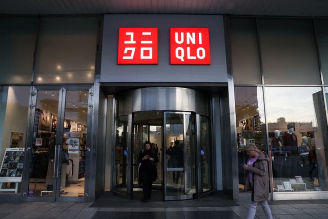 <p>People walk outside Uniqlo store in Warsaw</p>