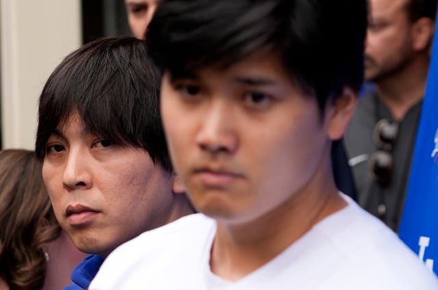 <p>Ippei Mizuhara, left, stands next to Los Angeles Dodgers baseball player Shohei Ohtani, right, during a February 2024 interview </p>