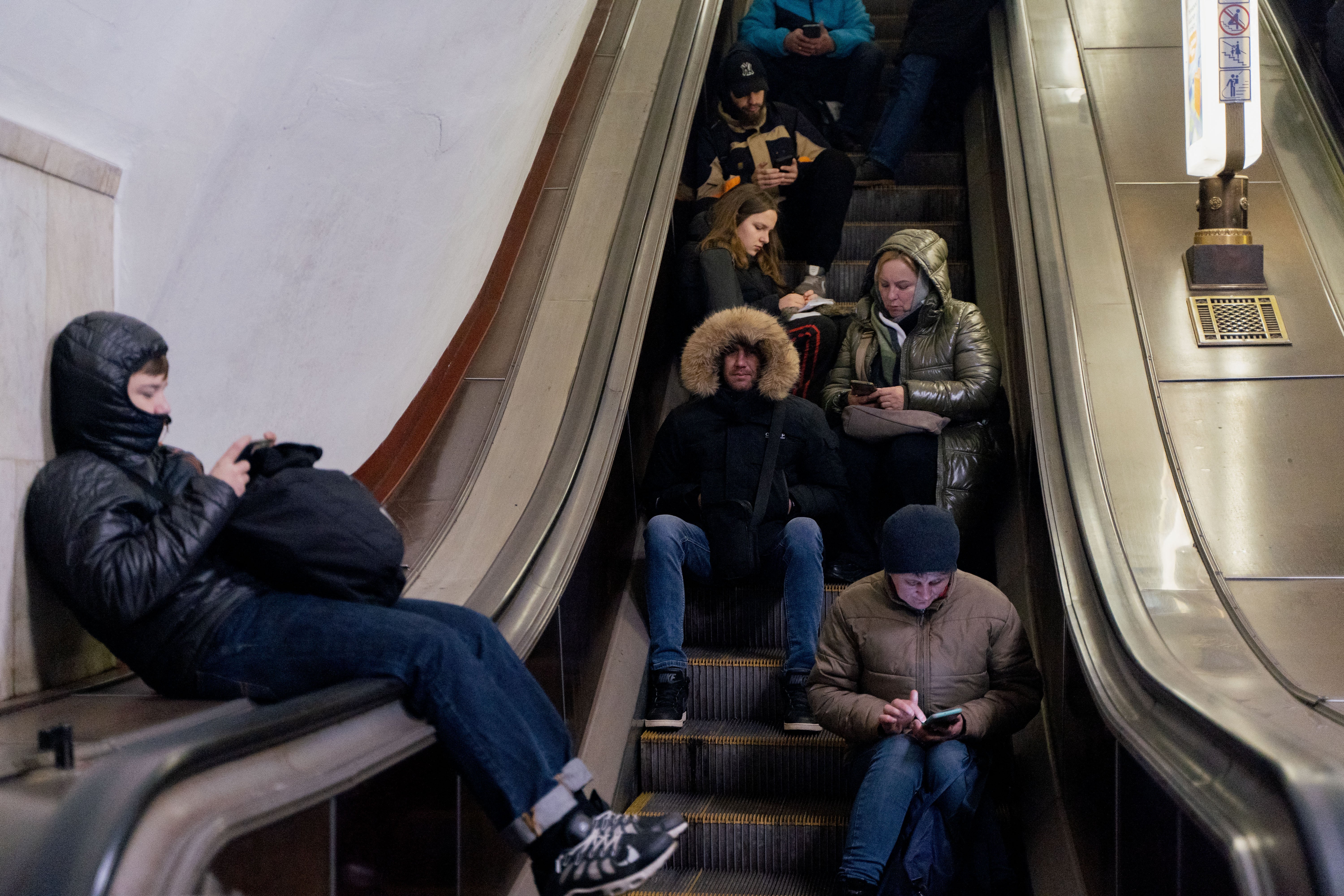 Local residents take shelter in a metro station during an air strike alarm in Kyiv on Thursday