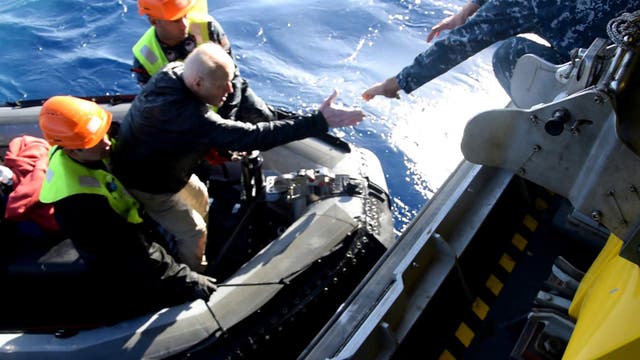 <p>A survivor is helped onboard the rescue vessel after it went down in rough waters in the Red Sea on Monday </p>