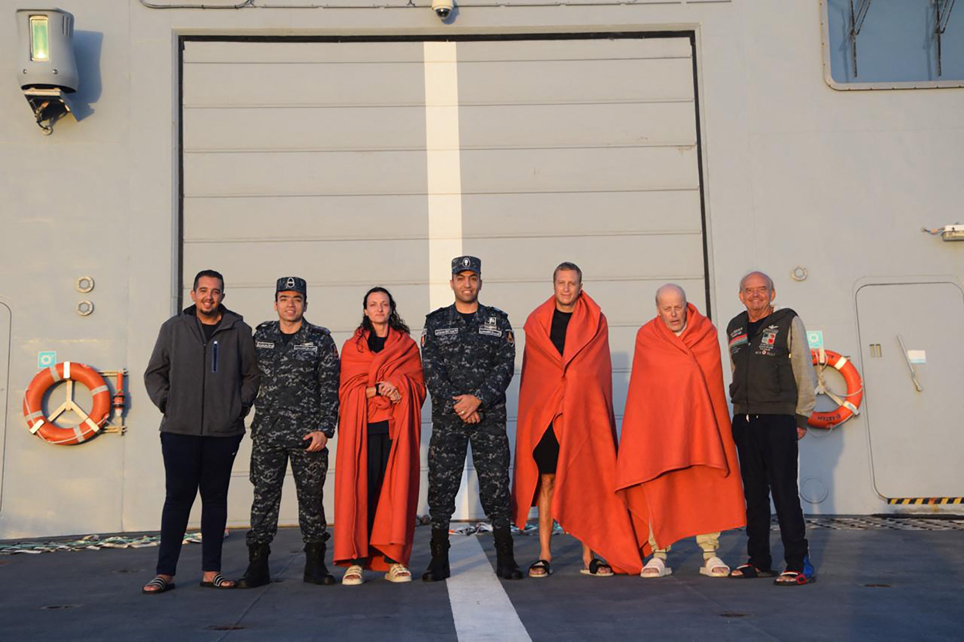 Survivors are wrapped in blankets after being rescued by Egyptian emergency services