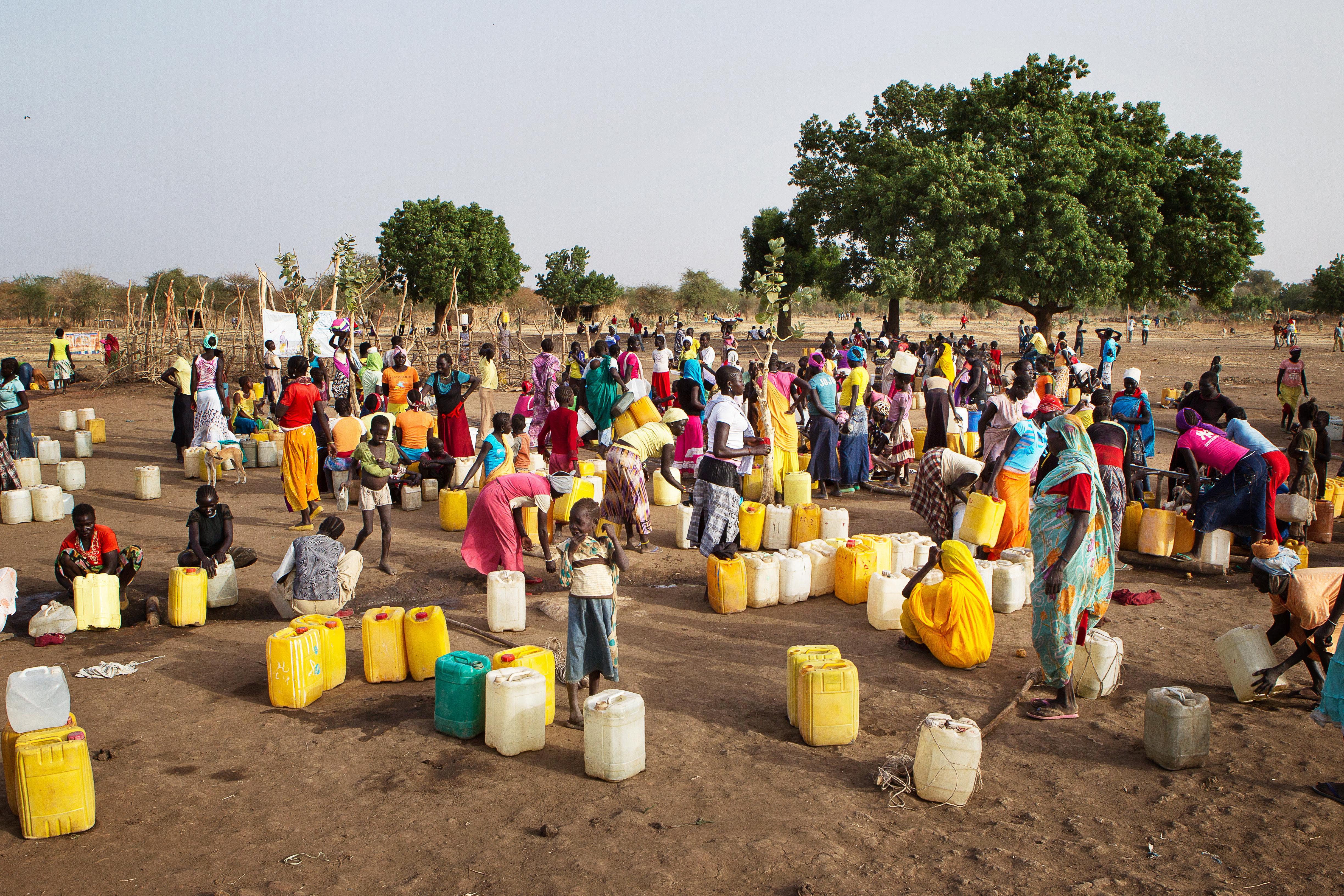 Refugees from fighting in Sudan collecting water in neighbouring South Sudan (Julien Behal/PA)