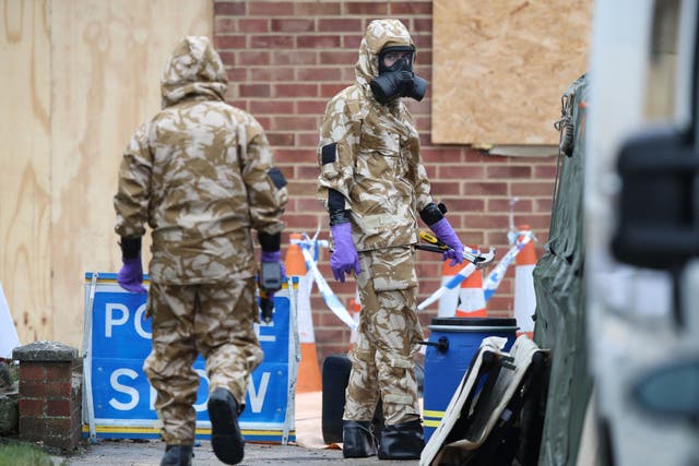 Members of the military wear protective clothing at the home of Sergei Skripal (Andrew Matthews/PA)