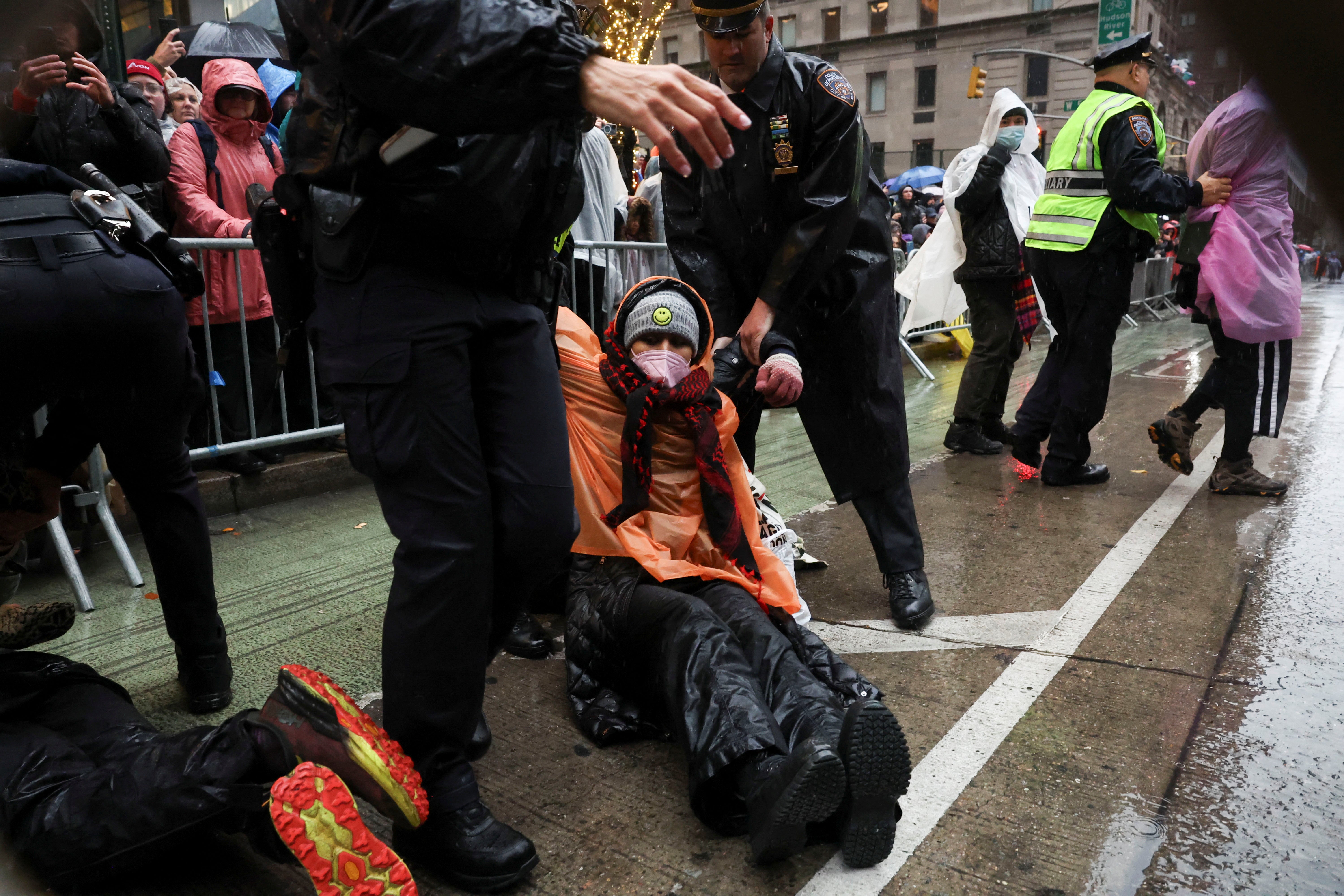 Police hold a pro-Palestinian protester who disrupted the Macy’s Thanksgiving Day Parade. A similar demonstration happened last year, with some 30 protesters interrupting the parade