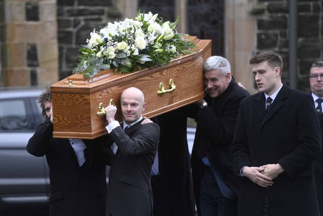 The coffin of veteran journalist and former UTV political editor Ken Reid is carried out of St Patrick’s Church in Ballymena (Mark Marlow/PA)