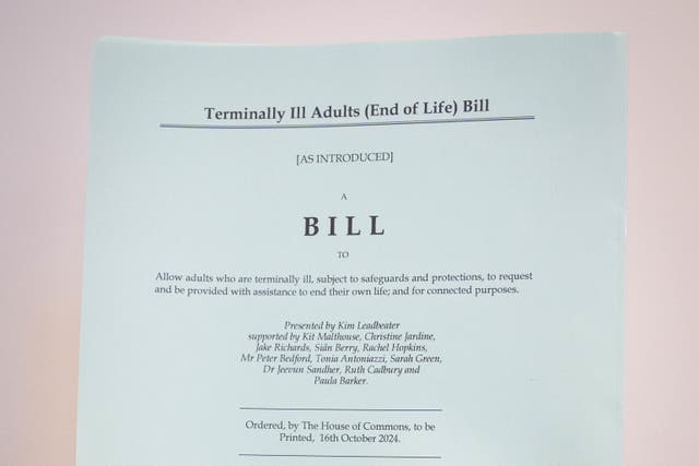 A person holds a hard copy of the Terminally Ill Adults (End of Life) Bill (Stefan Rousseau/PA)