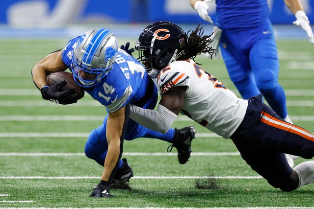 Detroit Lions wide receiver Amon-Ra St Brown is tackled by Chicago Bears cornerback Terell Smith (Duane Burleson/AP)