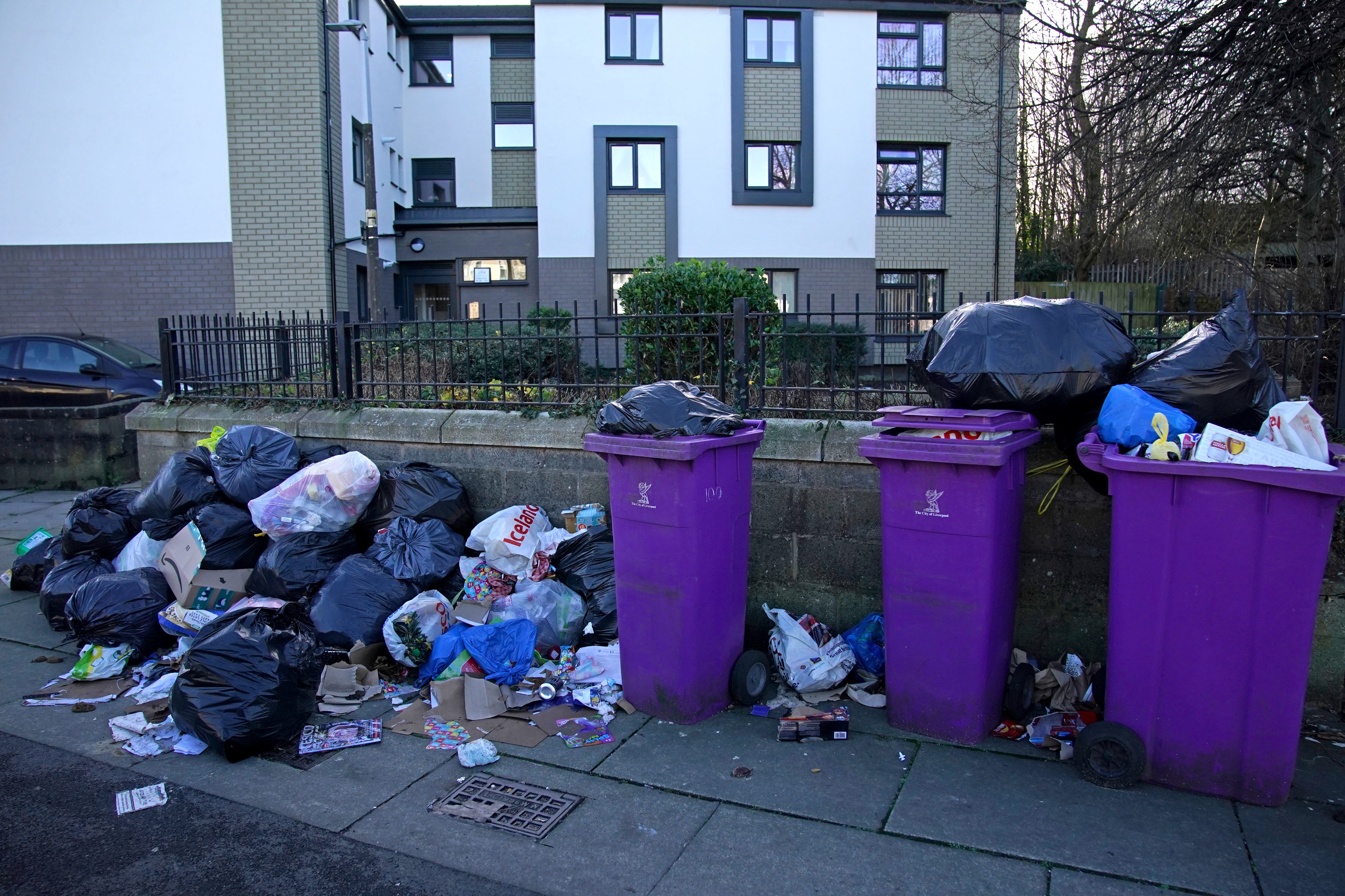 Overflowing bins awaiting collection by refuse workers on Cherry Street in the Walton area of Liverpool. (PA)