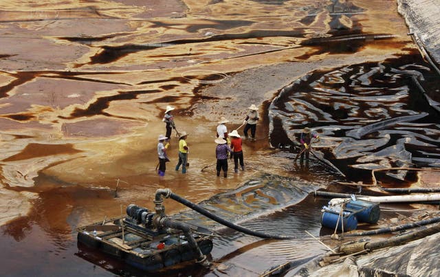 <p>File. Workers drain away polluted water near mine in Shanghang</p>