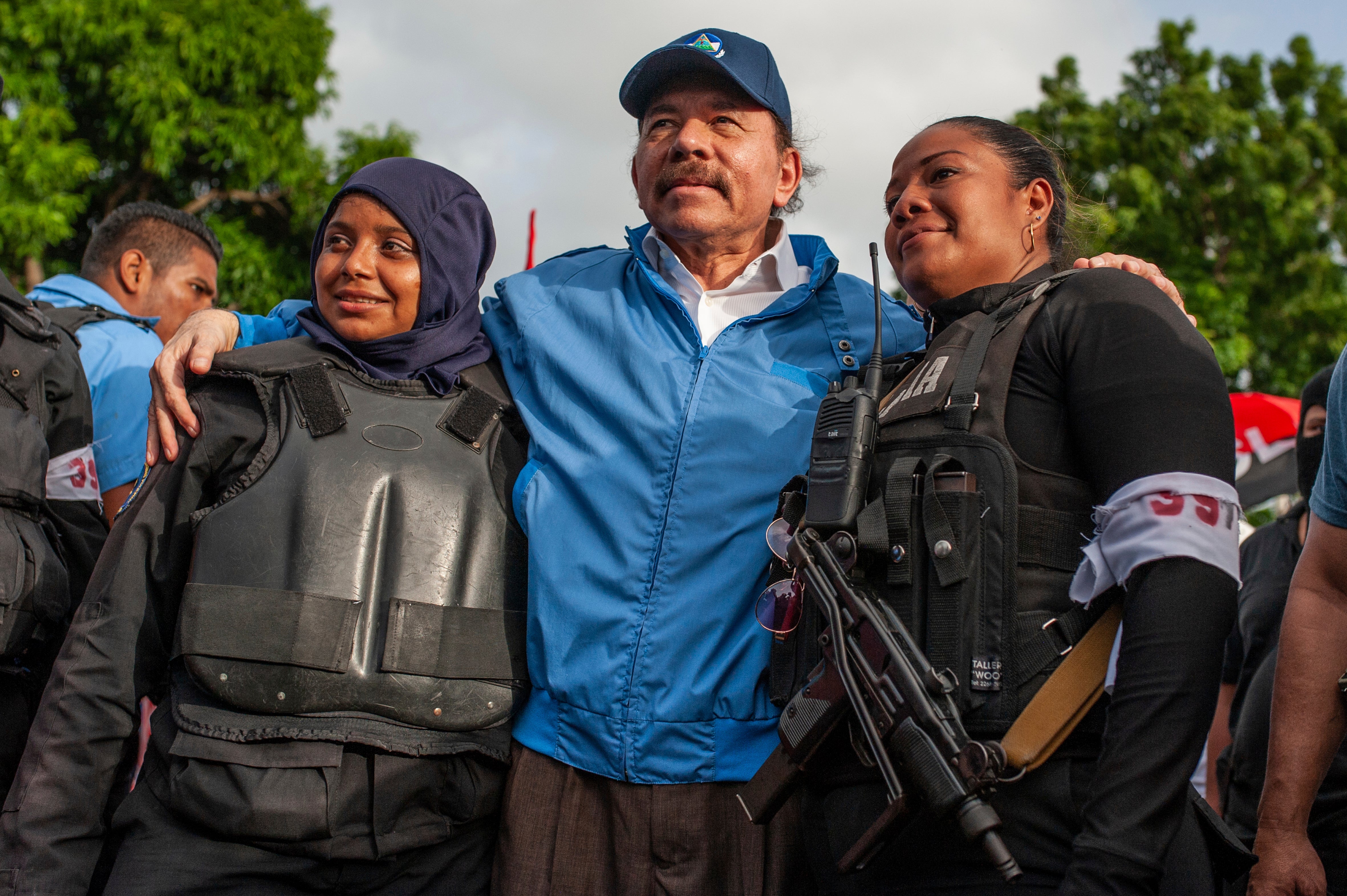 President Daniel Ortega poses for a photo with Nicaraguan riot police, after weeks of unrest in Masaya, in 2018