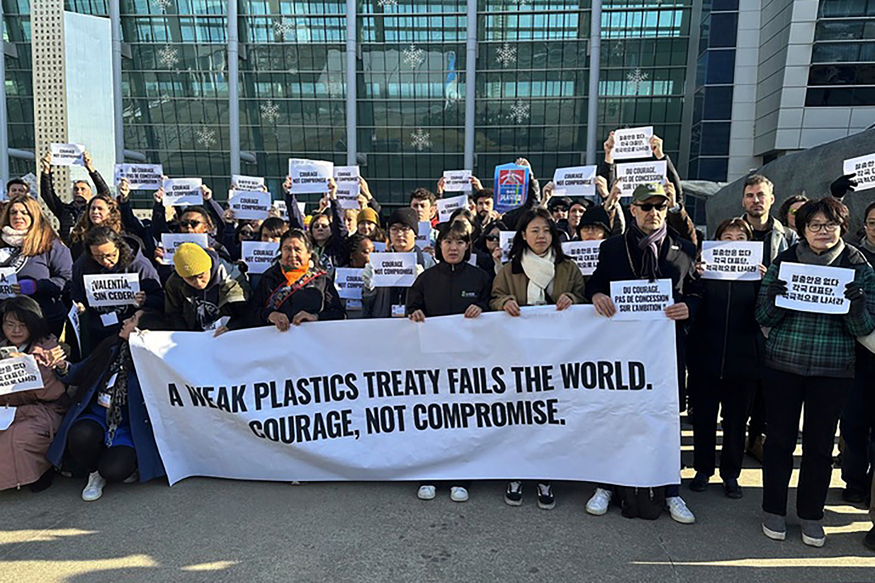 Environment activists hold a press conference calling for a strong global plastics treaty outside of the venue for the fifth session of the Intergovernmental Negotiating Committee on Plastic Pollution in Busan, South Korea