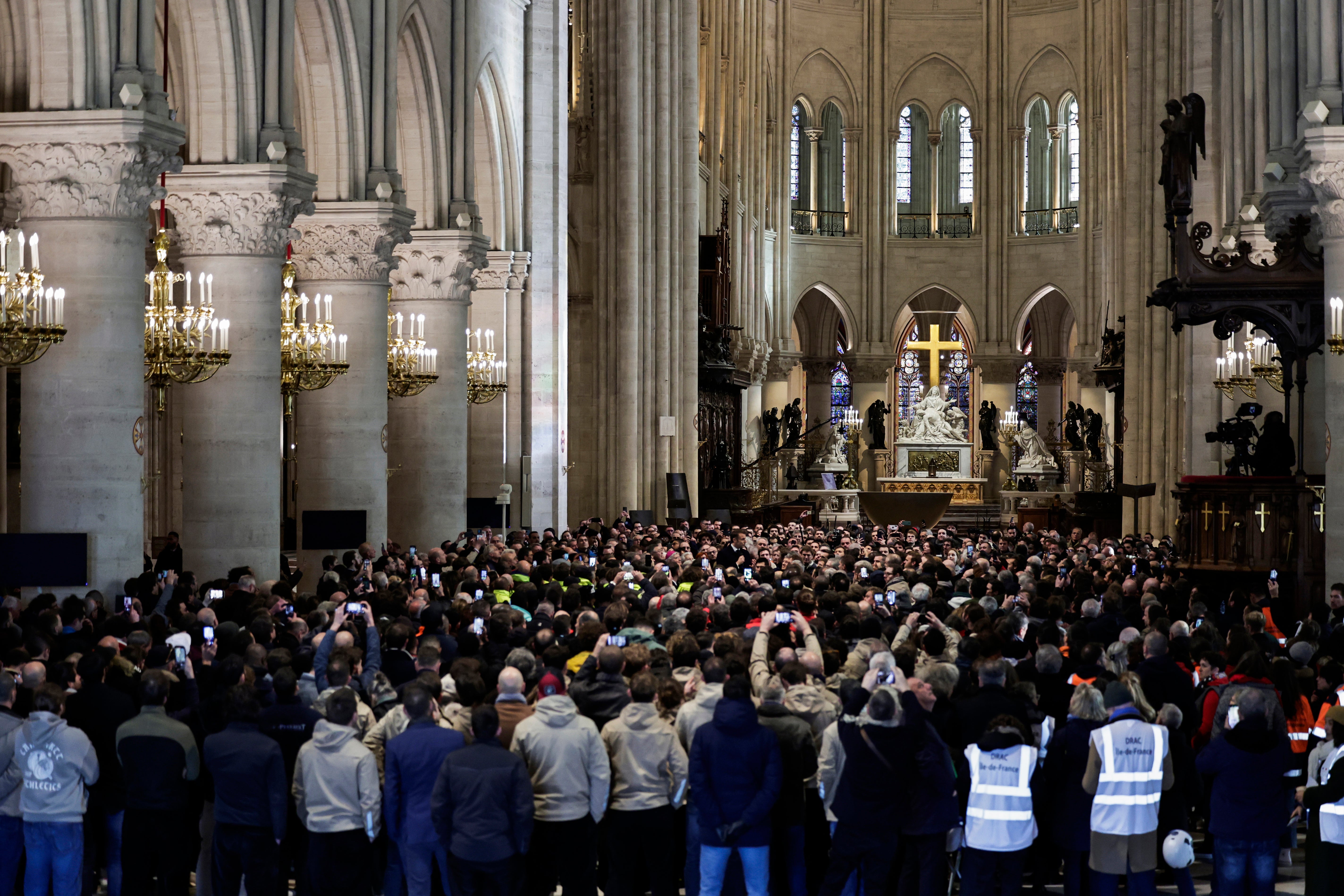 The French president delivers a speech to construction workers inside the newly restored Gothic masterpiece