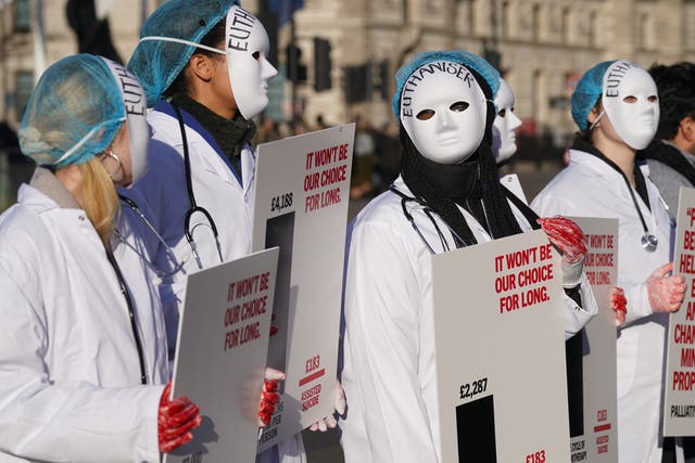 People take part in a demonstration outside the Houses of Parliament in Westminster, London (Stefan Rousseau/PA)