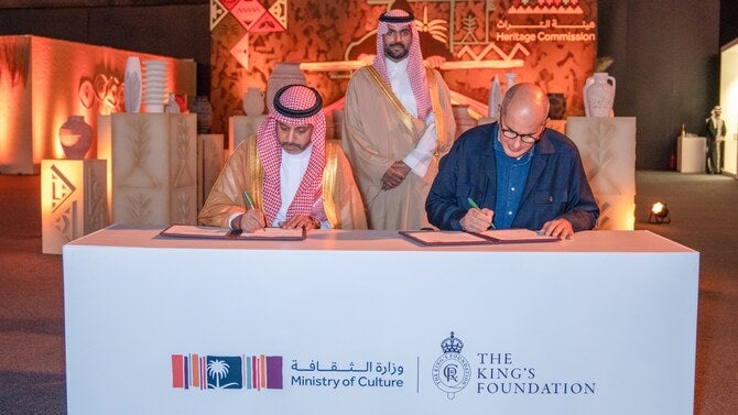 Khaled Omar Azzam, director of the traditional arts school at The King’s Foundation, and Hamed Fayez, Saudi deputy minister of culture, sign the agreement