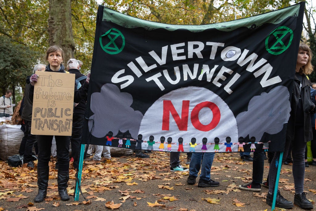 Stop Silvertown Tunnel activists hold a campaign banner in 2021