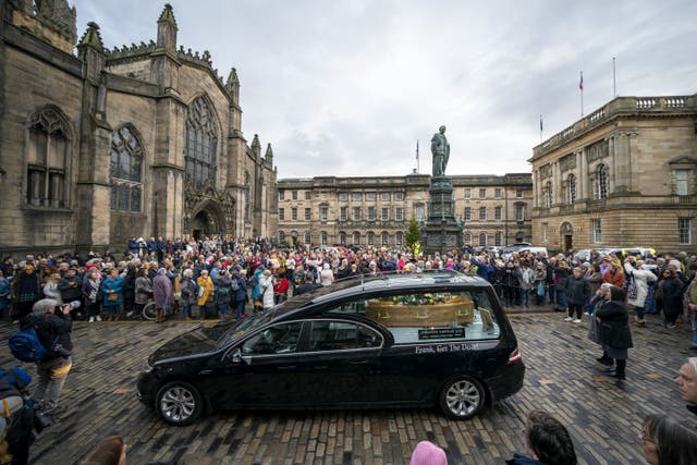 People lined the Royal Mile as Janey Godley’s hearse was taken through Edinburgh (Jane Barlow/PA)