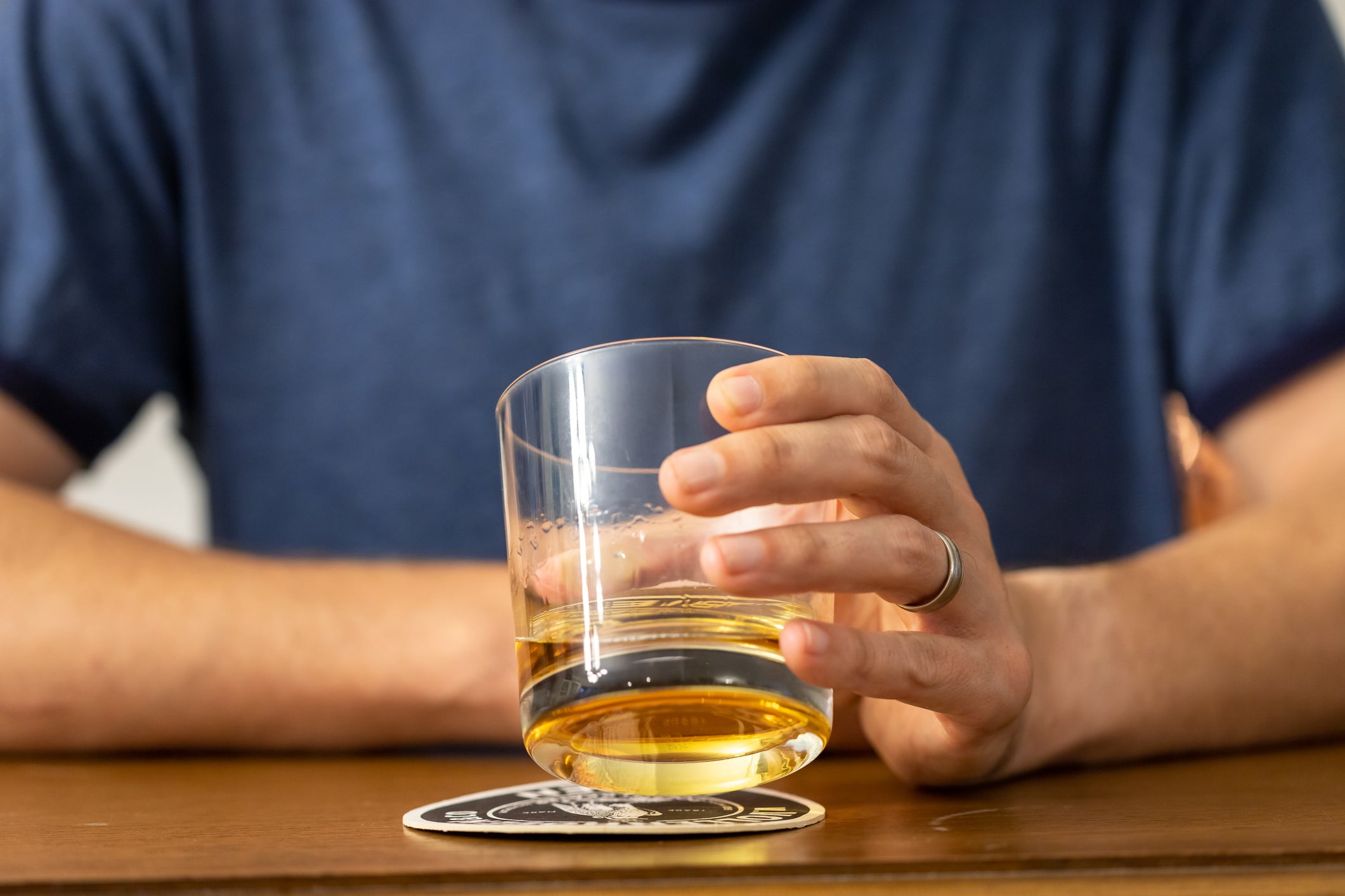 A man drinks at a bar. Scientists have found that hands may hold a vital clue to understanding drinking habits