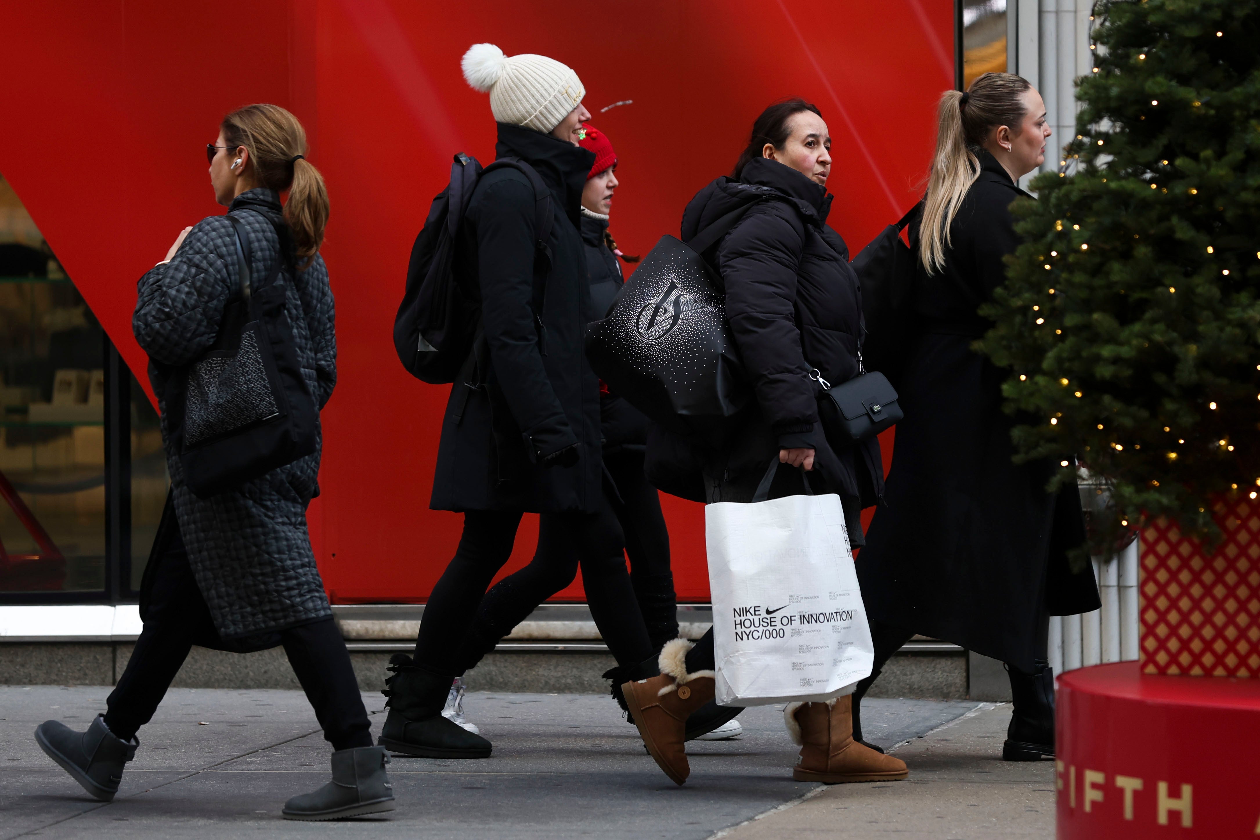 Shoppers walk along Fifth Avenue, Friday 29 November 2024 in New York