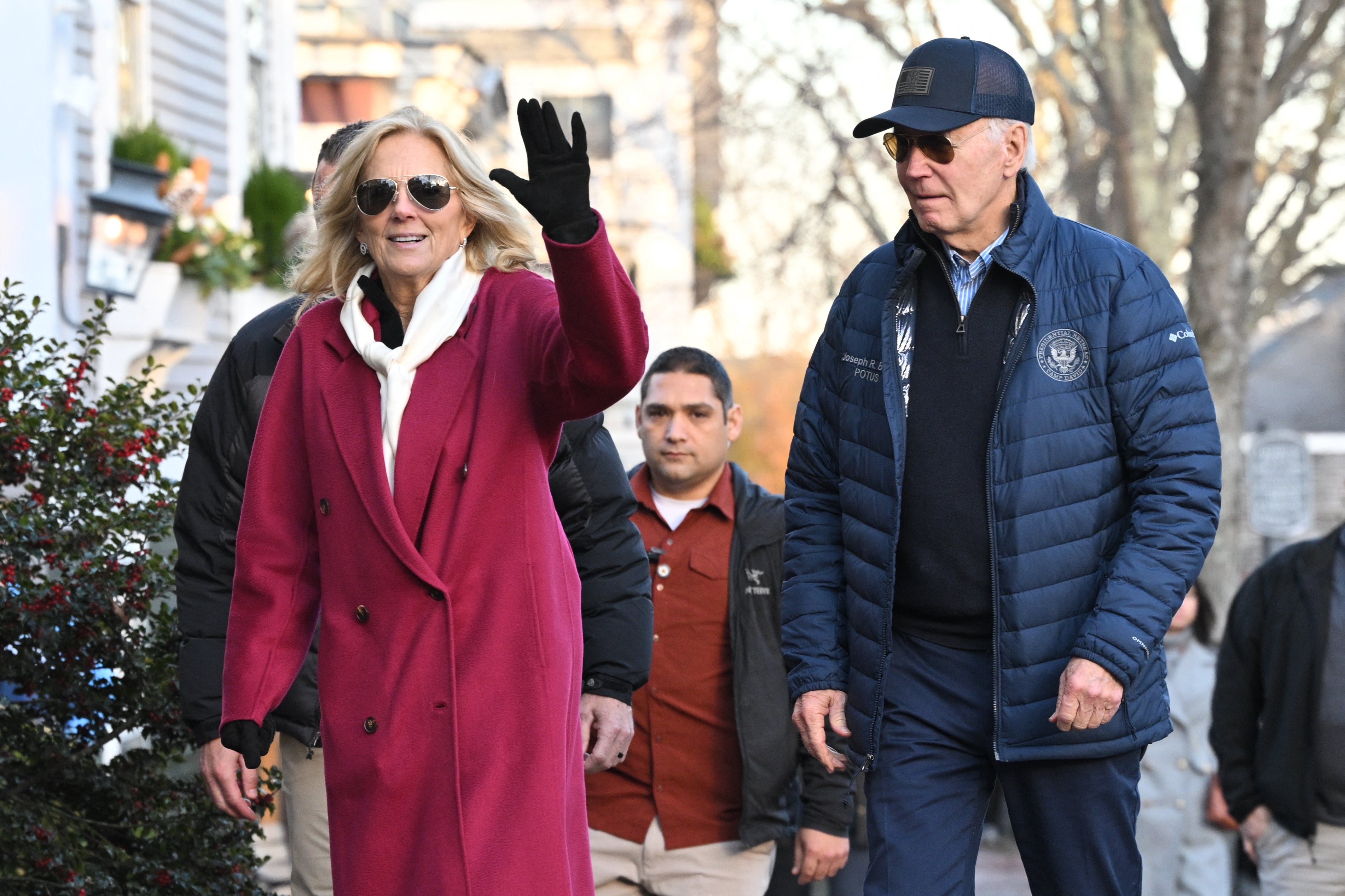 First Lady Jill Biden (L) waves as she and US President Joe Biden walk to a bookstore after having lunch at the Brotherhood of Thieves restaurant in Nantucket, Massachusetts