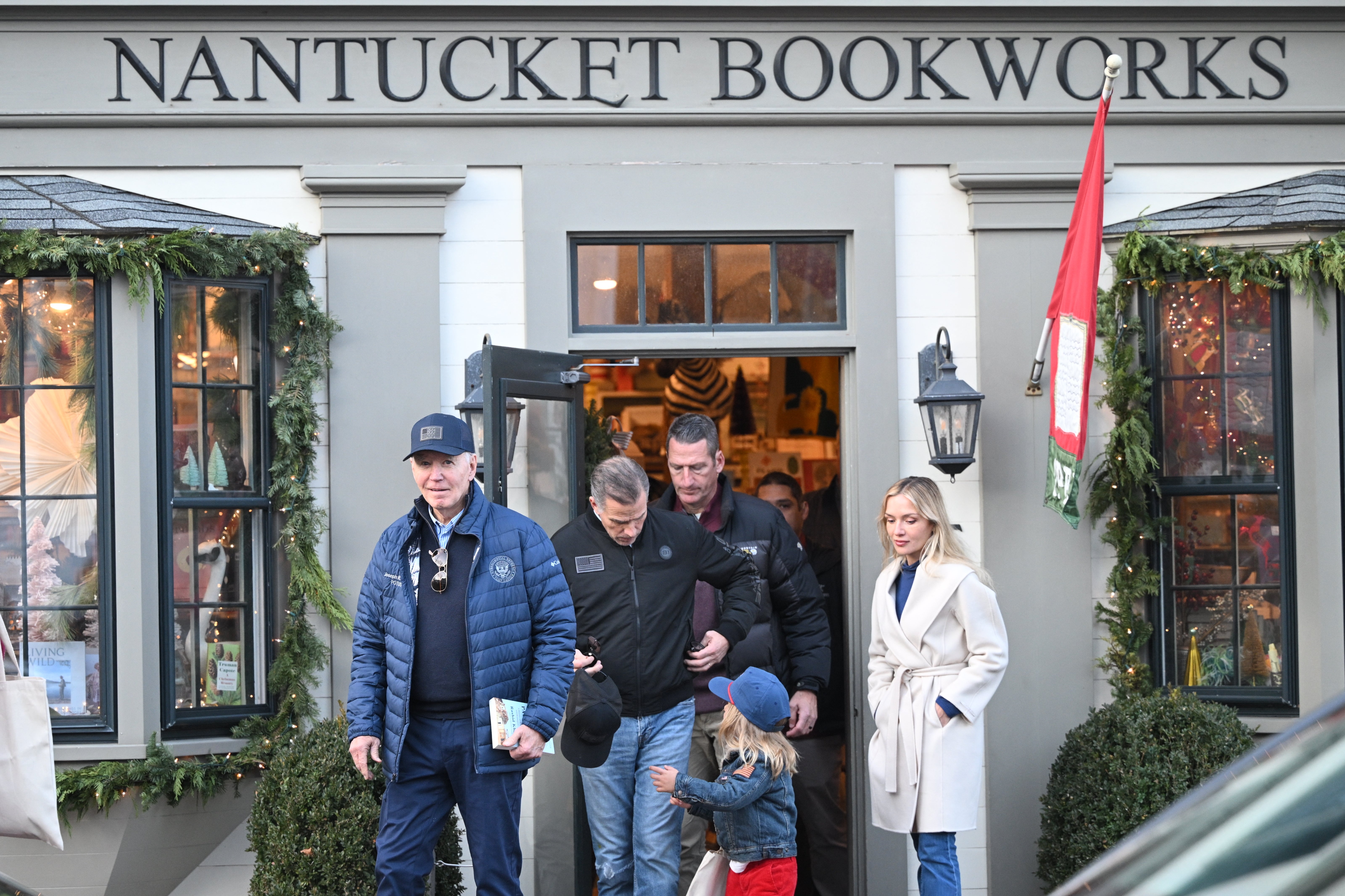 President Joe Biden (L) walks out of Nantucket Bookworks with son Hunter Biden, grandson Beau and daughter-in-law Melissa Cohen Biden