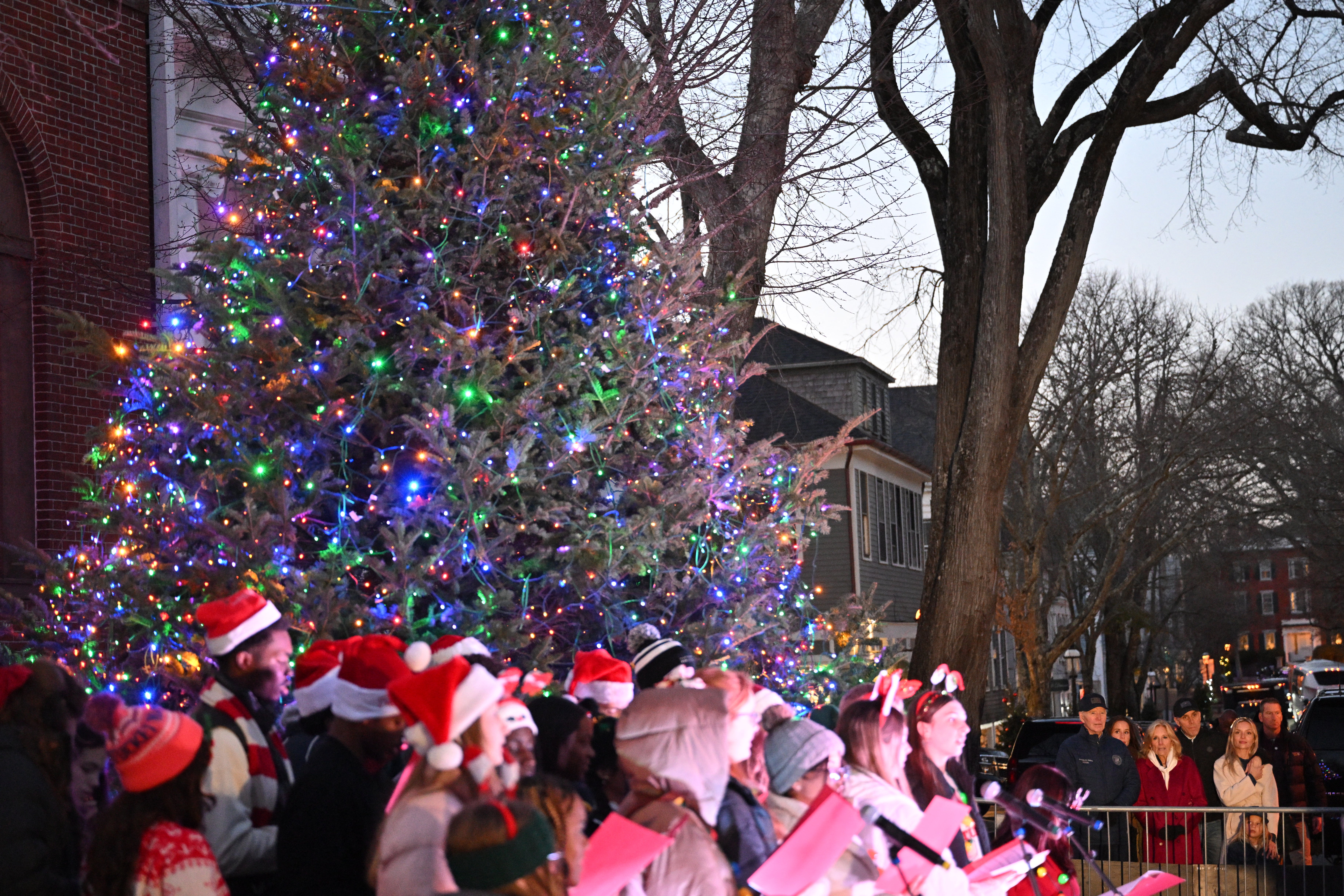 The first family (R) watch carolers at the Nantucket Christmas tree lighting ceremony