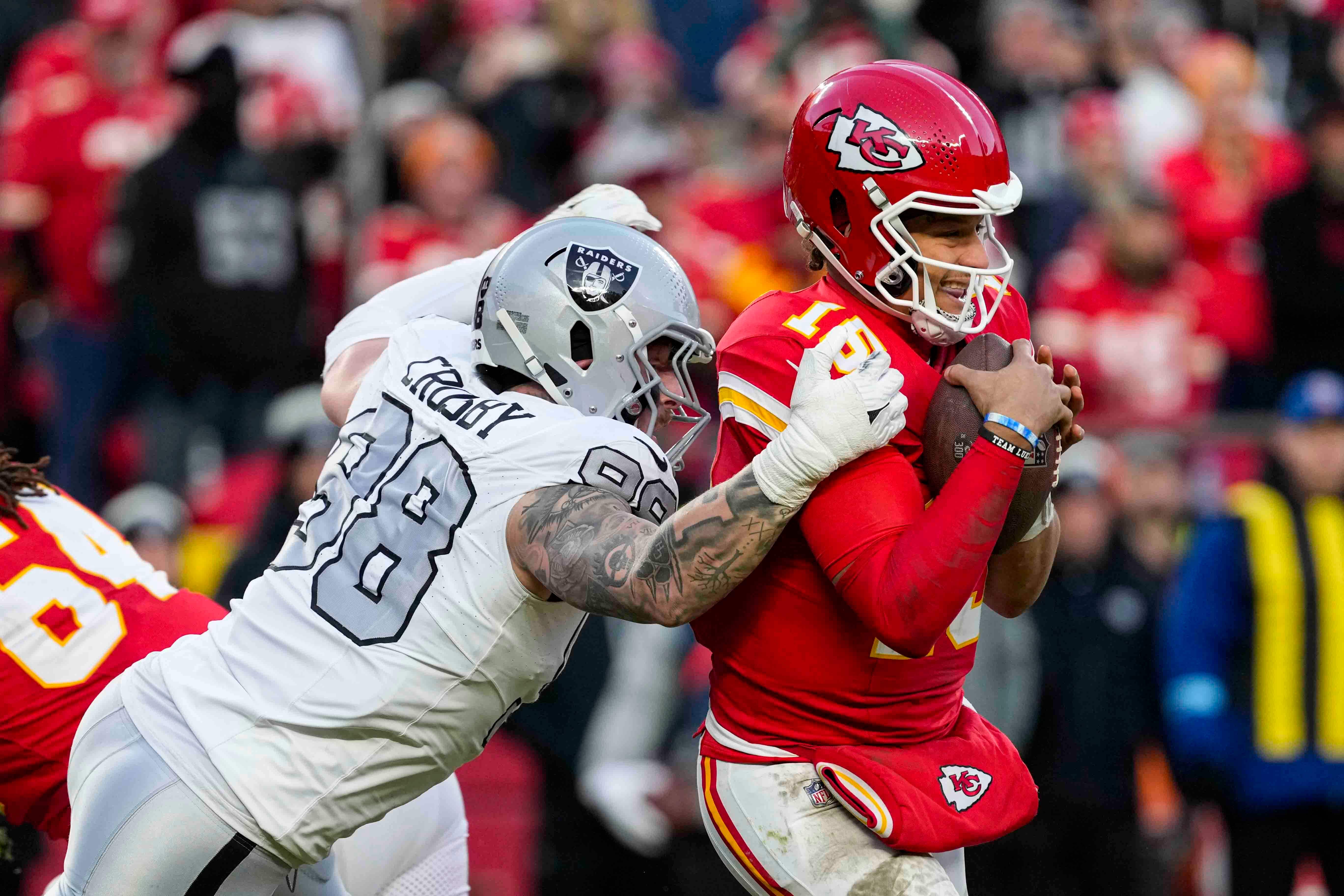 Las Vegas Raiders defensive end Maxx Crosby attempts to sack Kansas City Chiefs quarterback Patrick Mahomes (Ed Zurga/AP)