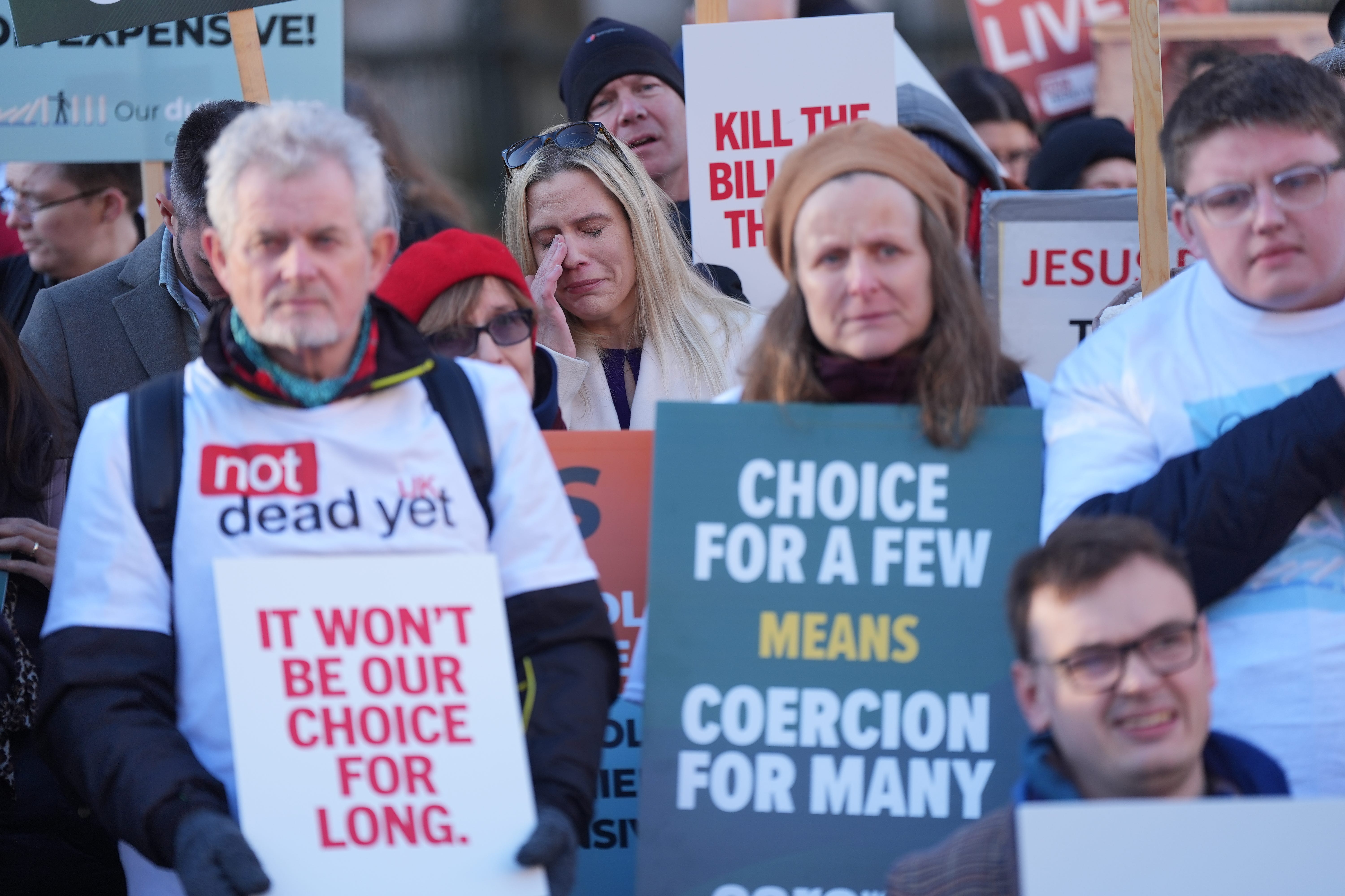 People take part in a demonstration at Old Palace Yard in Westminster, London, to oppose the Terminally Ill Adults (End of Life) Bill (Yui Mok/PA)