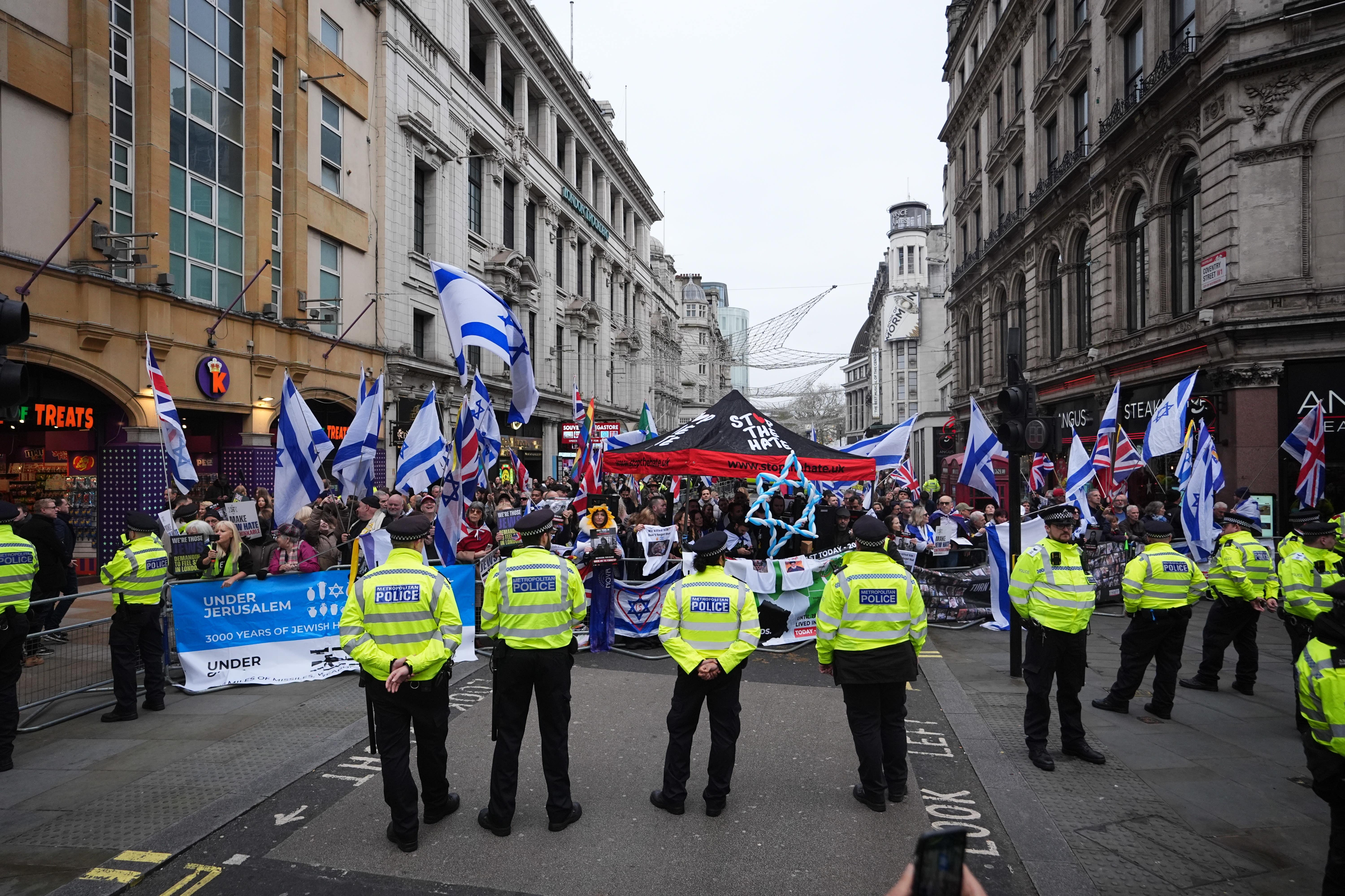 Police watch a counter-protest near Piccadilly Circus during a Palestine Solidarity Campaign rally in central London (James Manning/PA)