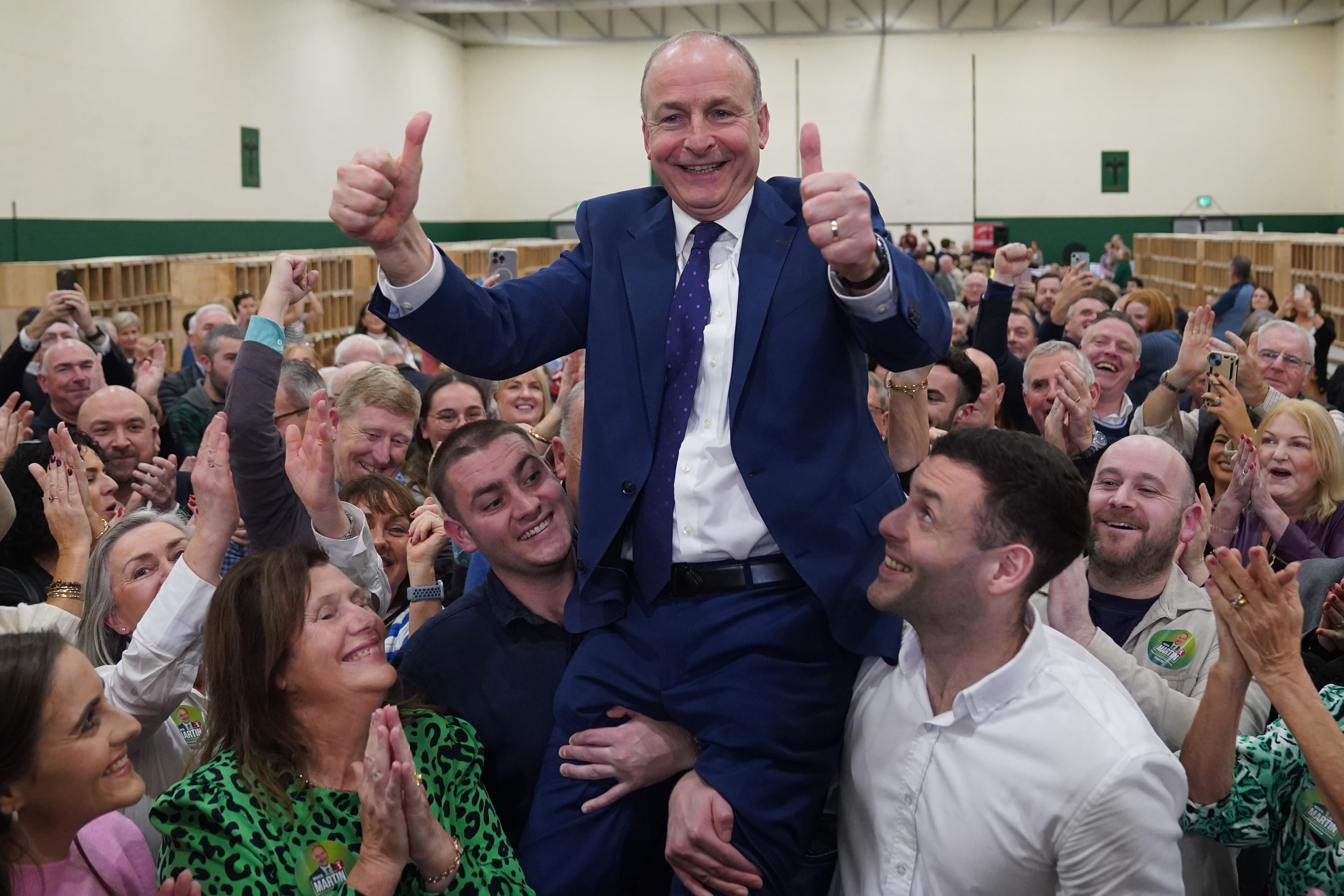 Fianna Fail leader Micheal Martin is hoisted up by his sons Cillian and Micheal Aodh (Jacob King/PA)