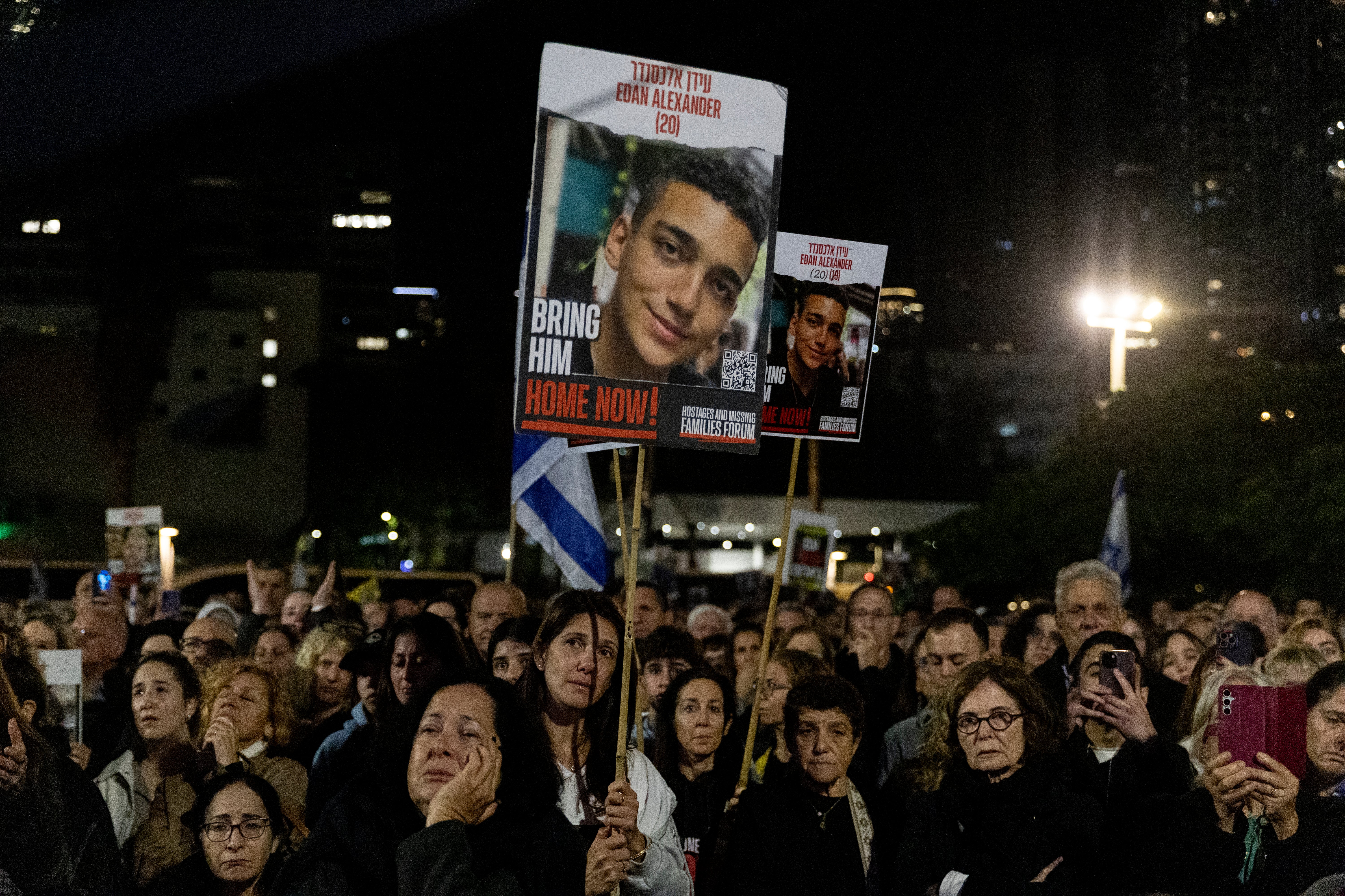 Protesters hold up photos of hostage Eden Alexander during a rally calling on Israeli prime minster Benjamin Netanyahu to end the war in Gaza