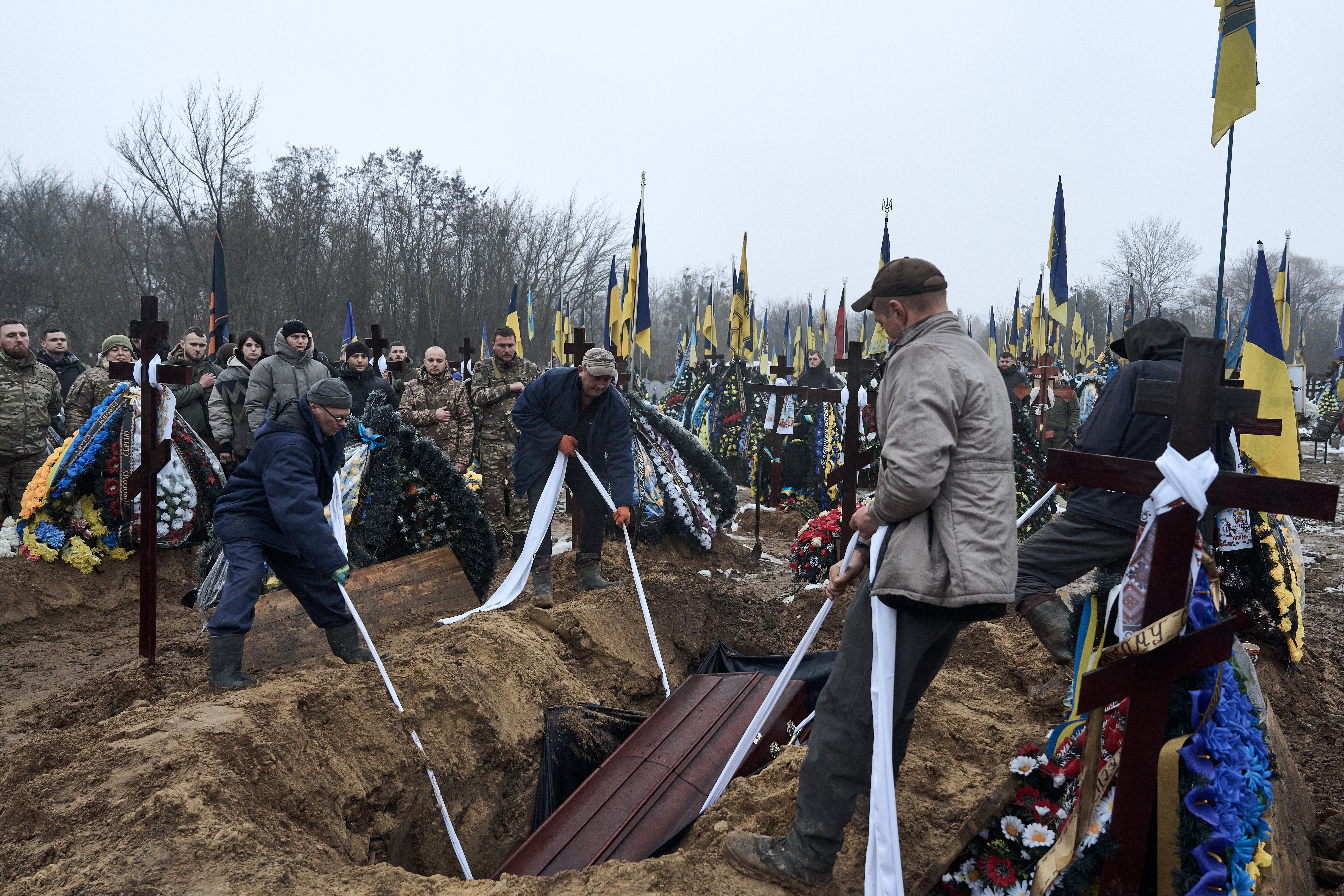 Mourners attend a Ukrainian soldier’s burial in Kyiv, Ukraine.