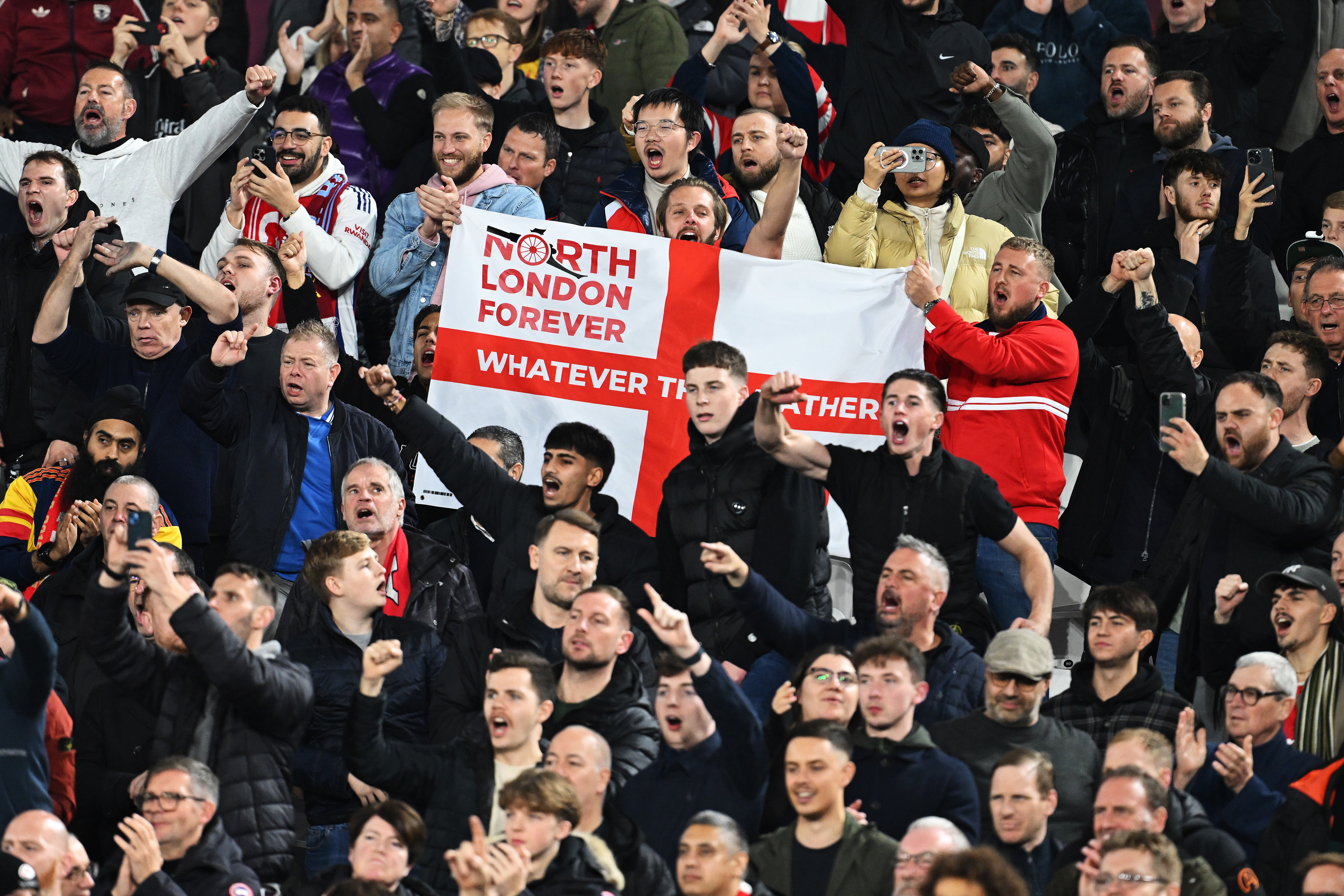 Fans of Arsenal celebrate at West Ham