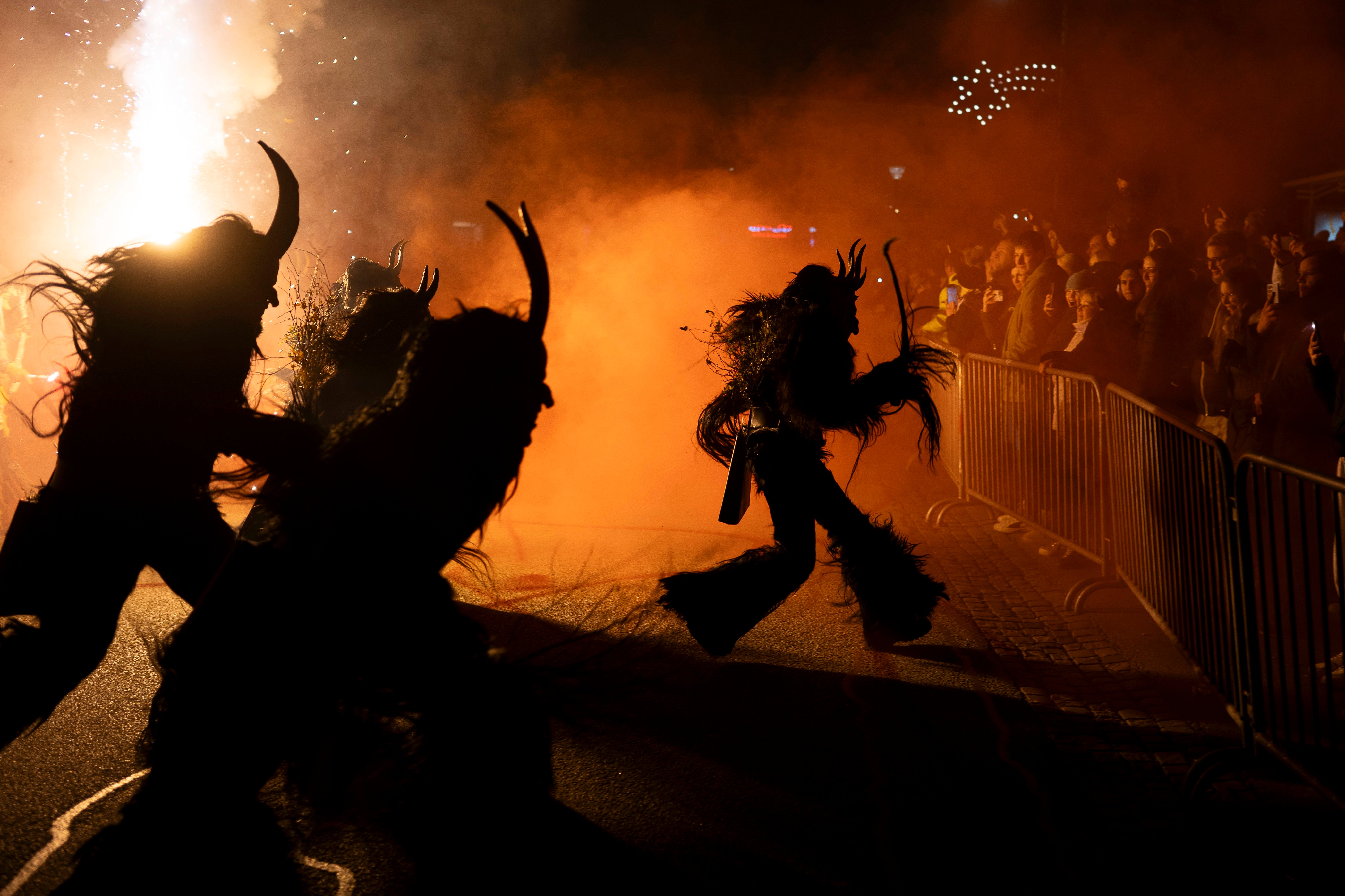 Participants wearing traditional Krampus costumes perform during a Krampus run in Hollabrunn, Austria