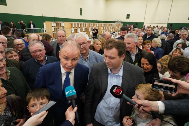 <p>Fianna Fail party leader Micheal Martin, stands with Padraig O’Sullivan who was elected for Cork North-Central, during the count for the Irish general election </p>