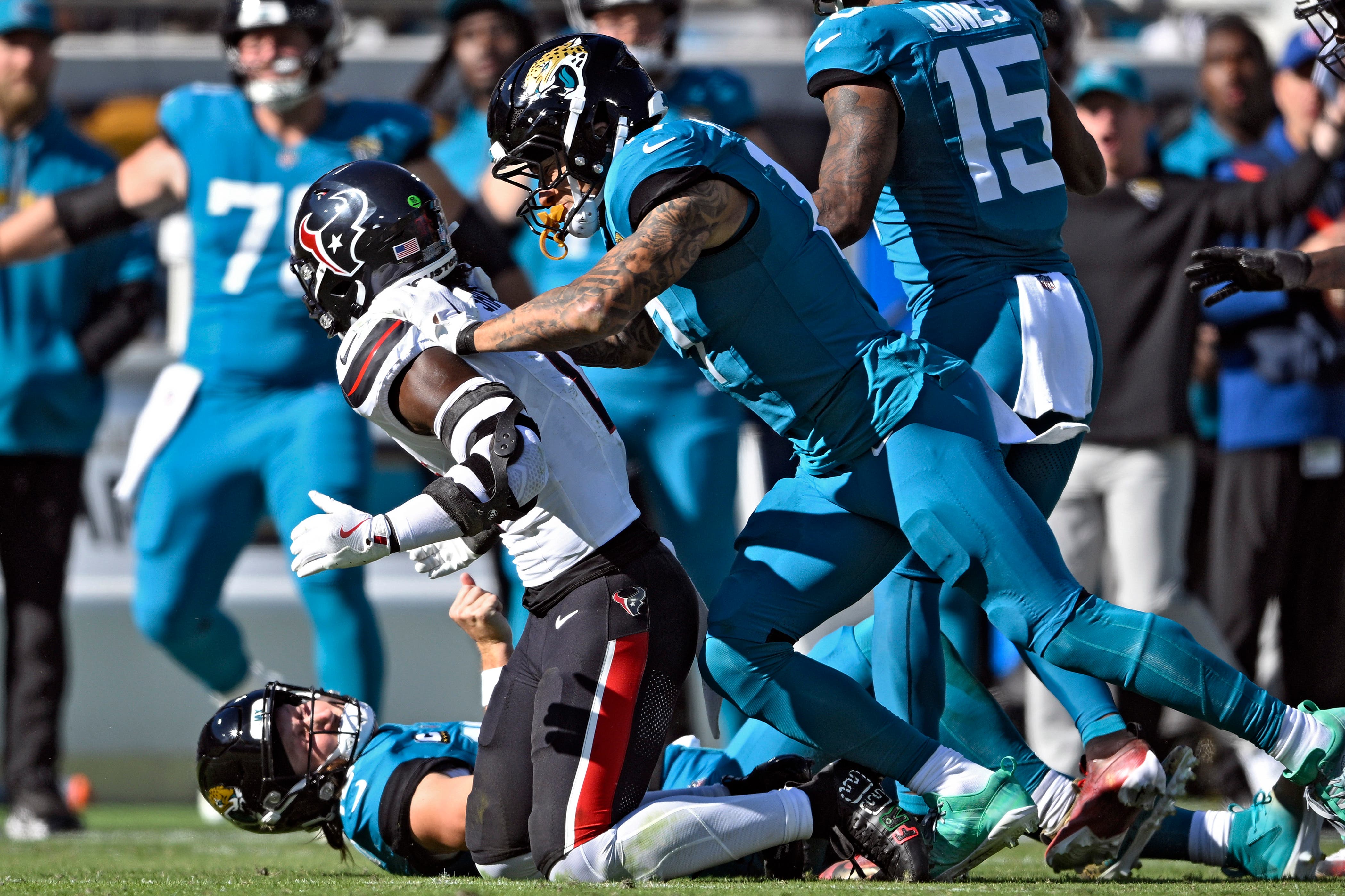 A violent hit from Azeez Al-Shaair (left) on Trevor Lawrence sparked a brawl as the Houston Texans beat the Jacksonville Jaguars (Phelan M. Ebenhack/AP)