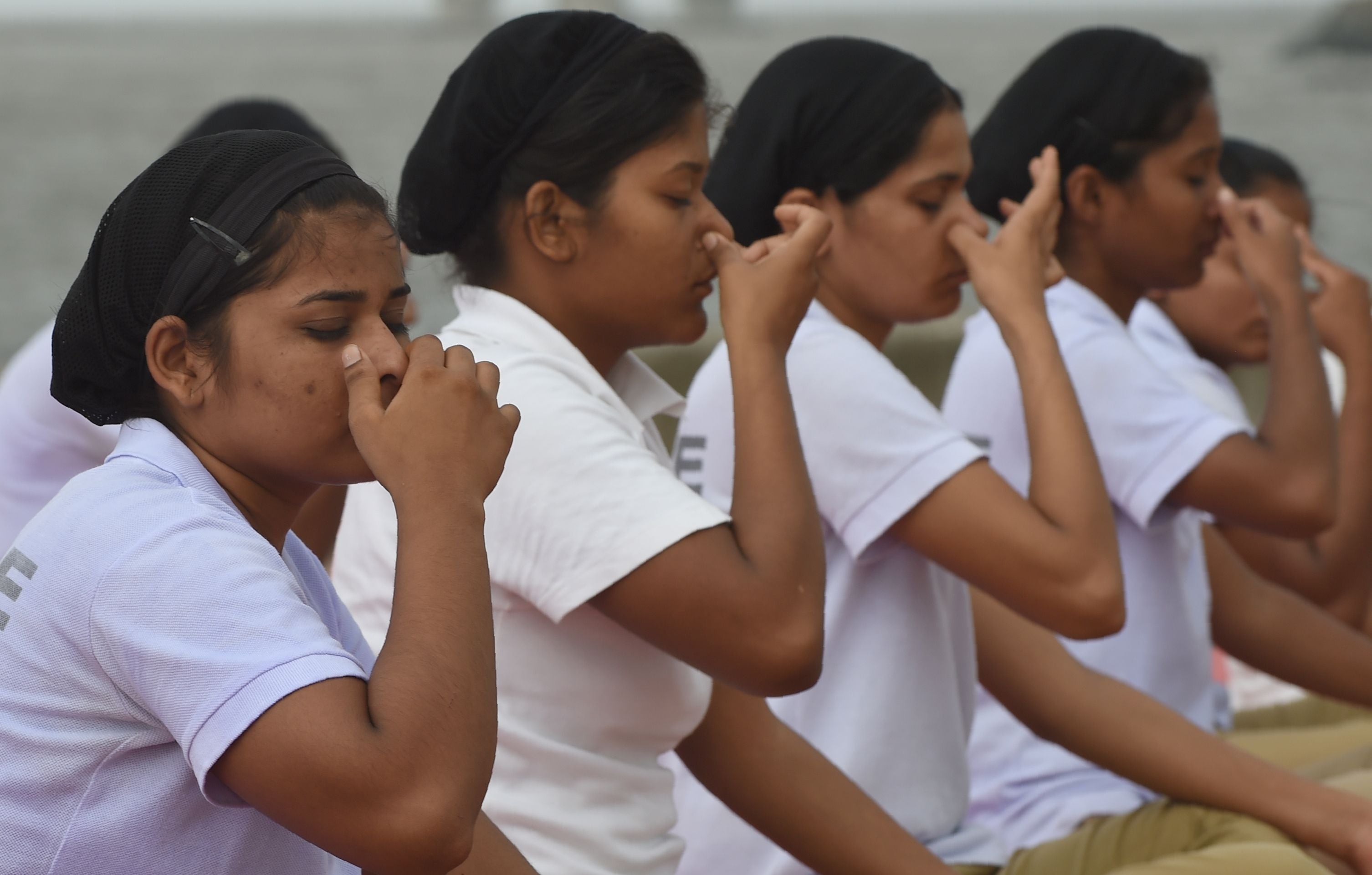 <p>File. Indian policewomen do ‘pranayam’ breathing exercise during a mass yoga session</p>