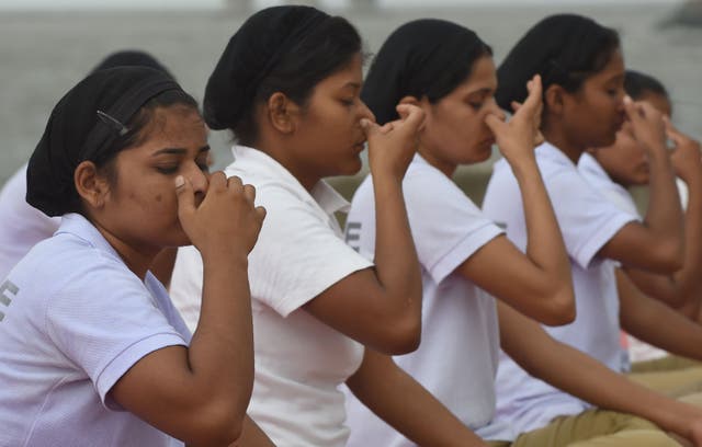 <p>File. Indian policewomen do ‘pranayam’ breathing exercise during a mass yoga session</p>