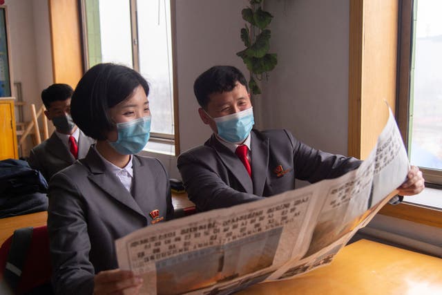 <p>File. Students at  the Pyongyang Jang Chol Gu University of Commerce look at the Rodong Sinmun newspaper containing news of the previous day’s launch of the Hwasong-17 missile</p>