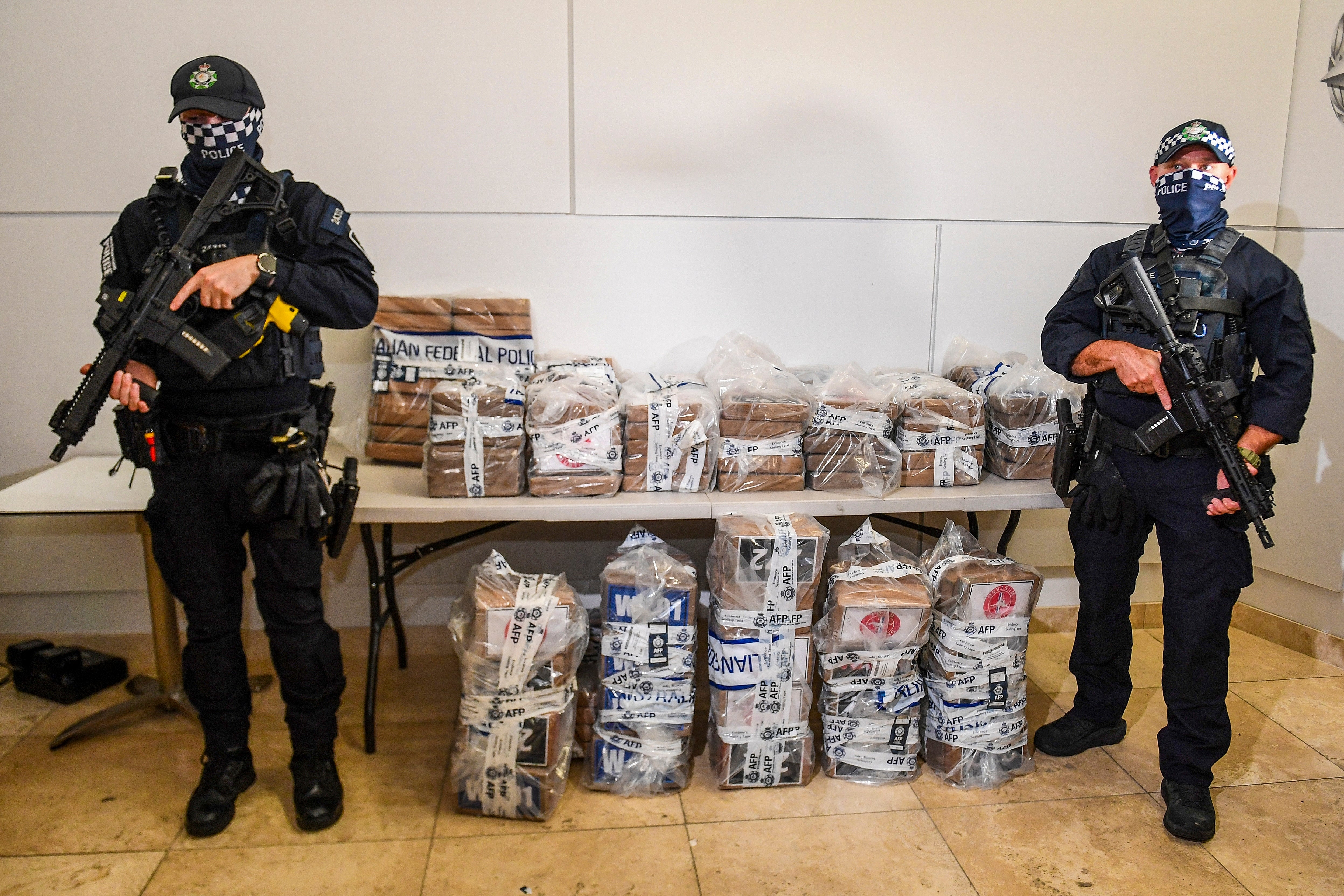 <p>Australian police officers stand with about 350kg of seized cocaine at a press conference in Brisbane </p>