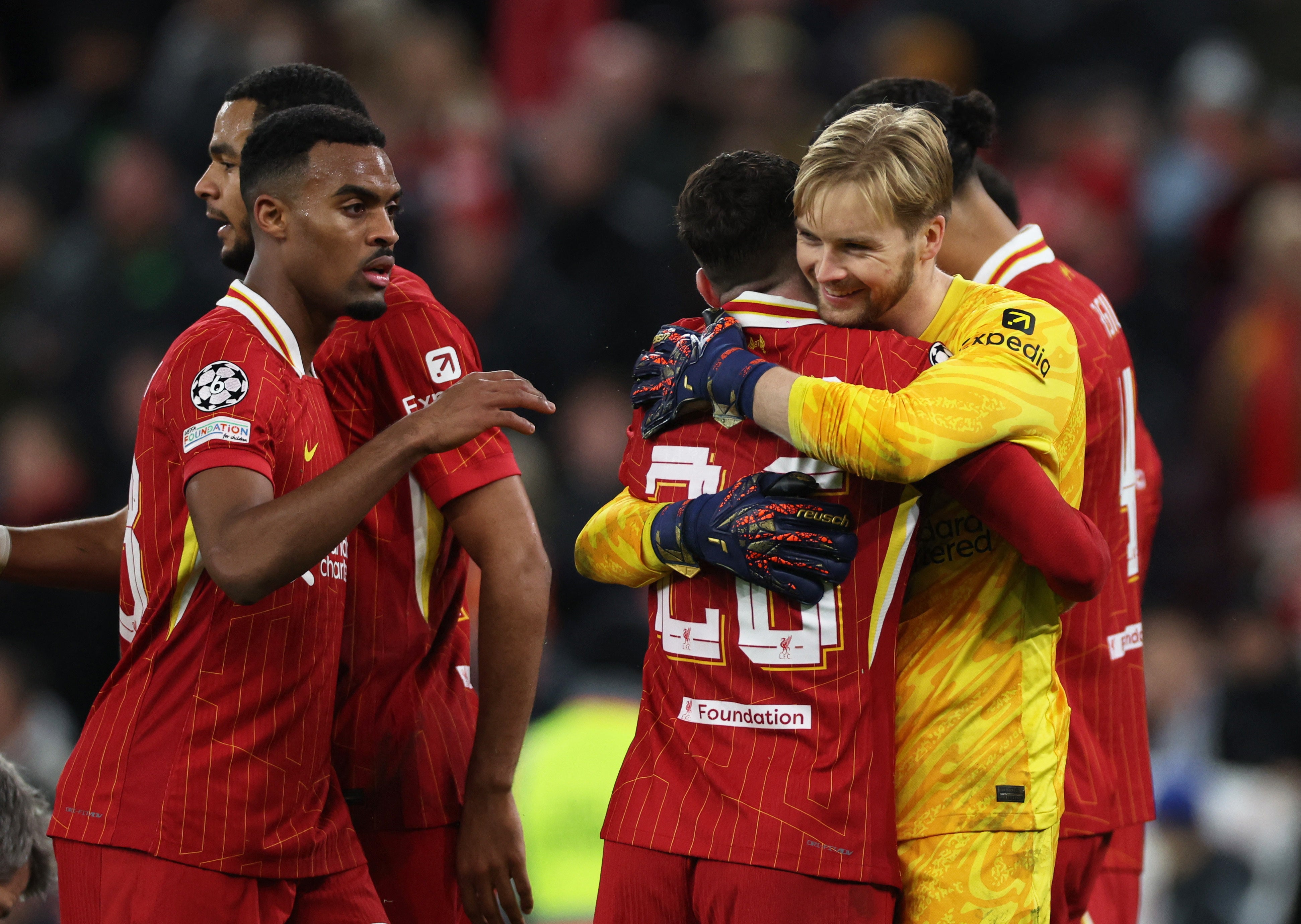 Ryan Gravenberch, Caoimhin Kelleher and Andrew Robertson celebrate after Liverpool beat Real Madrid