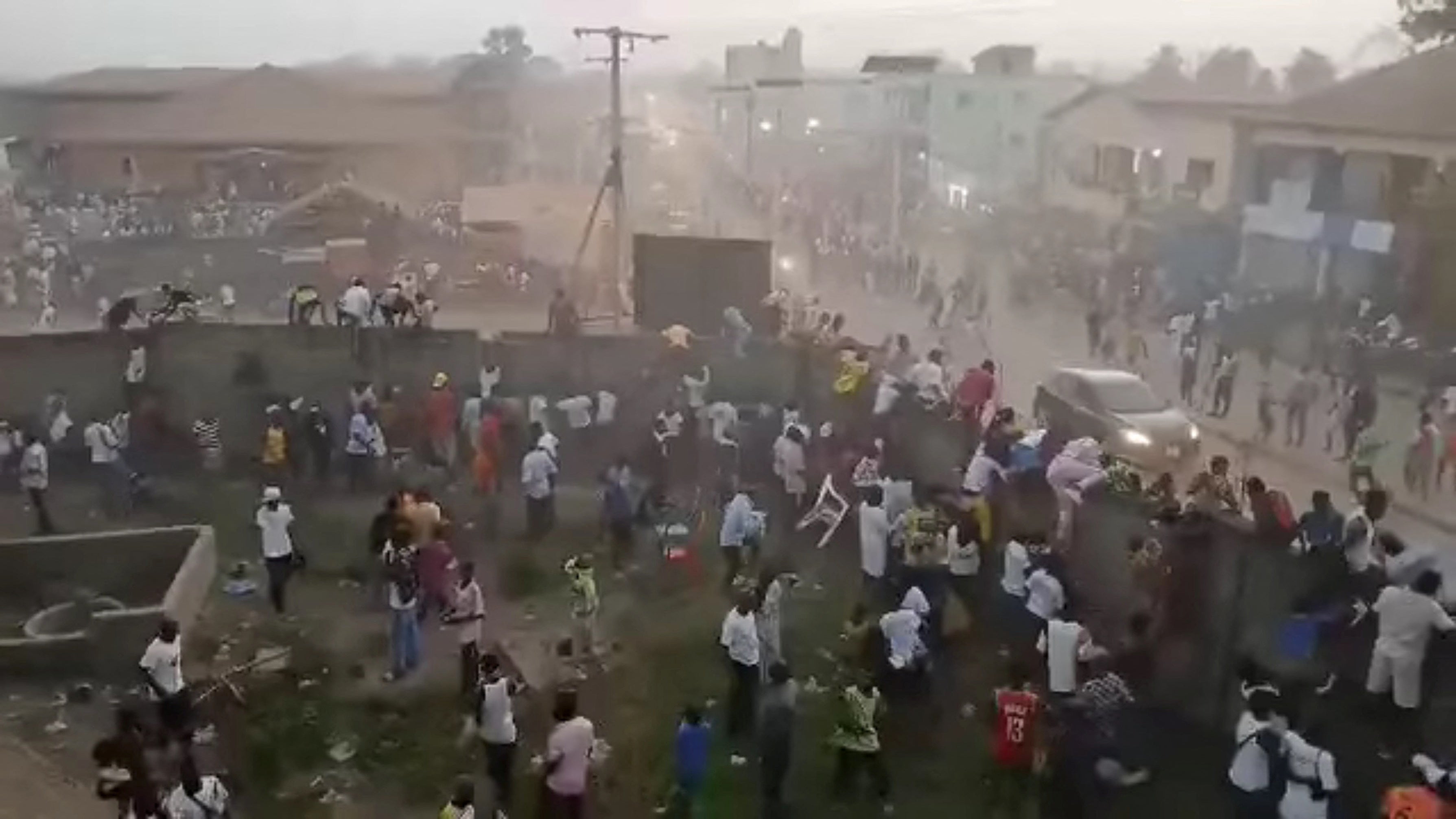 People scramble in Nzerekore, Guinea, where local officials said a deadly stampede ensued at a stadium following fan clashes during a soccer match, 1 December 2024, in this still image obtained from a social media video