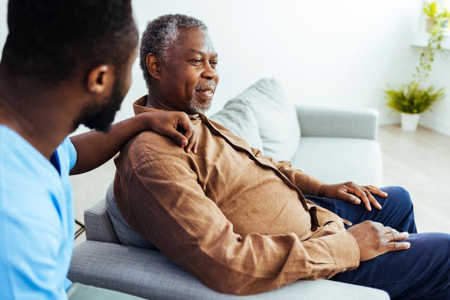 <p>A caregiver sits with a senior man. Nearly 7 million Americans have Alzheimer’s disease. It was the fifth-leading cause of death among individuals ages 65 and up in 2021. Now, new research is tying visceral fat to hallmarks of Alzheimer’s disease </p>